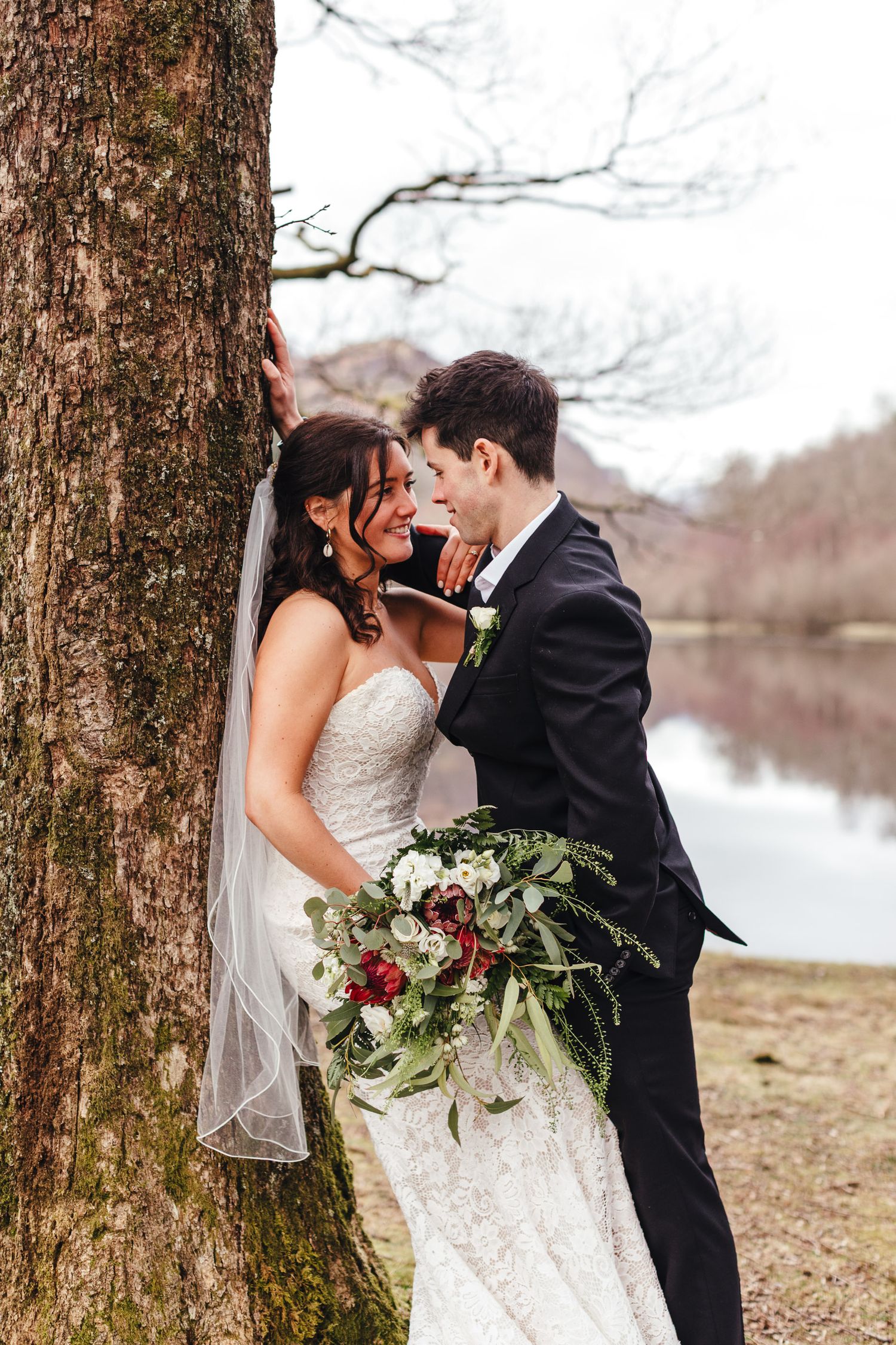 Lake District wedding couple portrait by lakeside tree, photographed by Derbyshire wedding photographer