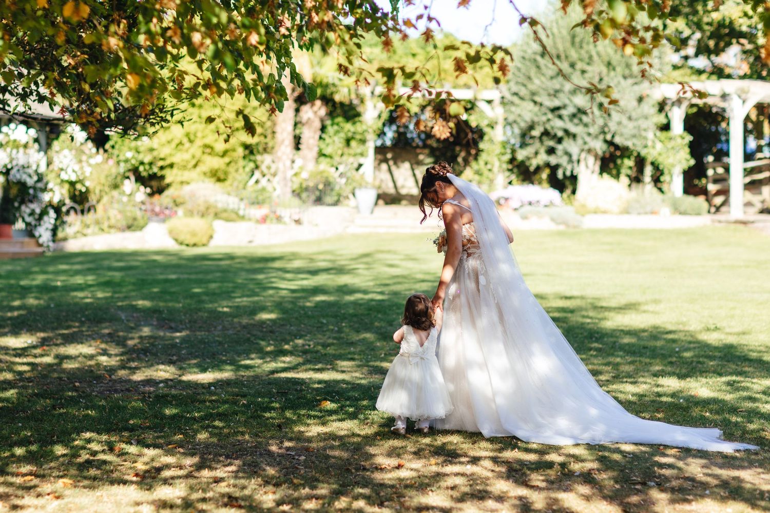 Bride and flower girl in gardens at Cooling Castle Barn Kent wedding