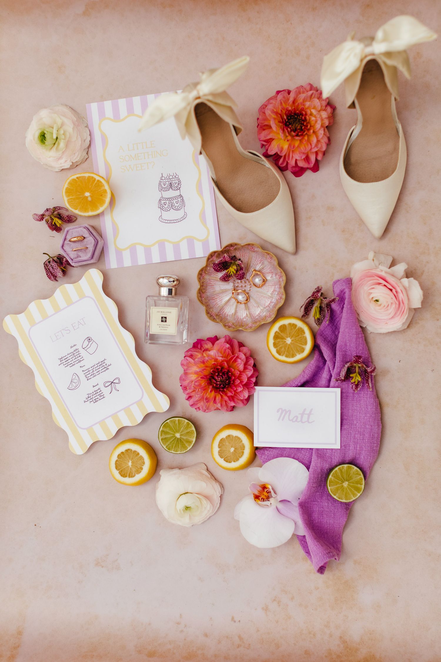 Spring wedding flat lay at Syon Park London with pastel stationery and citrus details, elegant natural light wedding photography