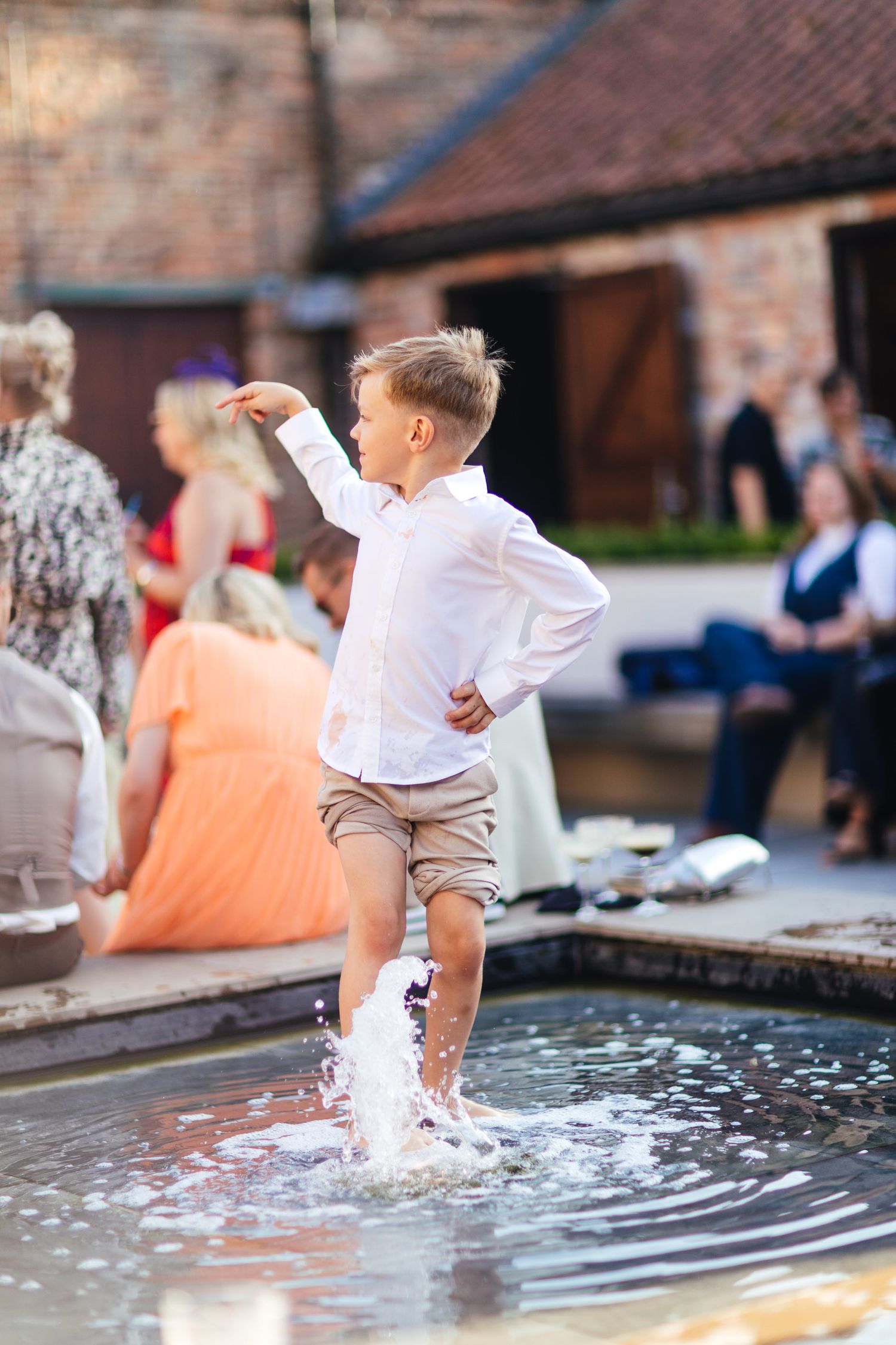 The Normans York wedding photography, candid summer guest moment at luxury North Yorkshire barn venue