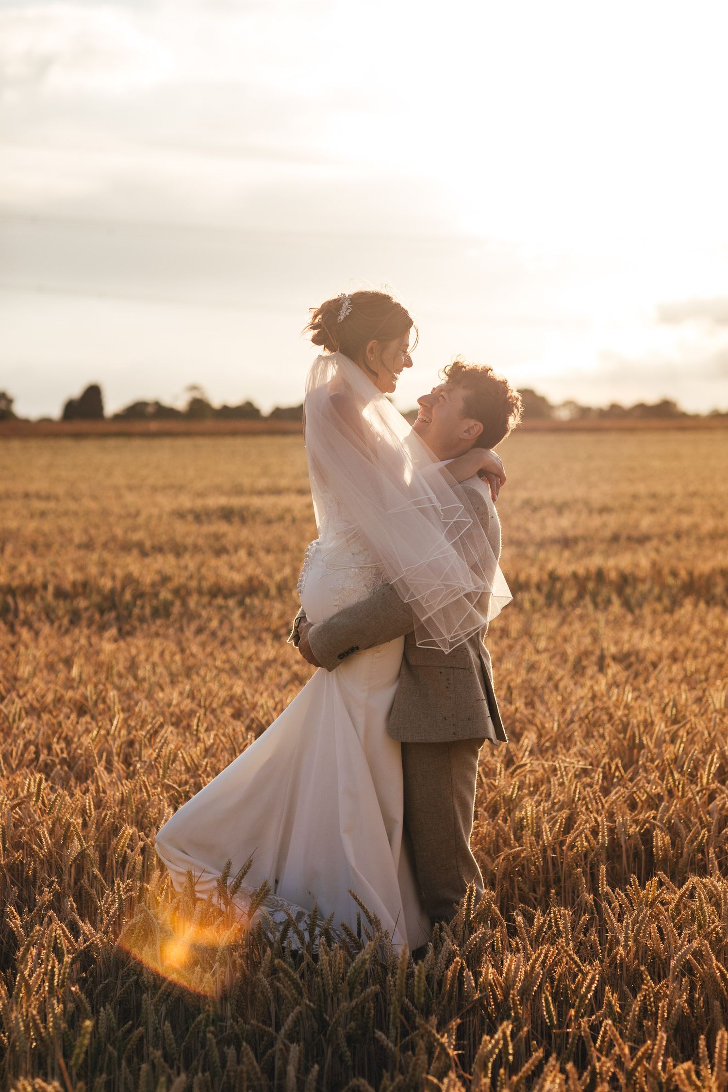 Romantic sunset wedding portrait in Derbyshire countryside by Derbyshire wedding photographer