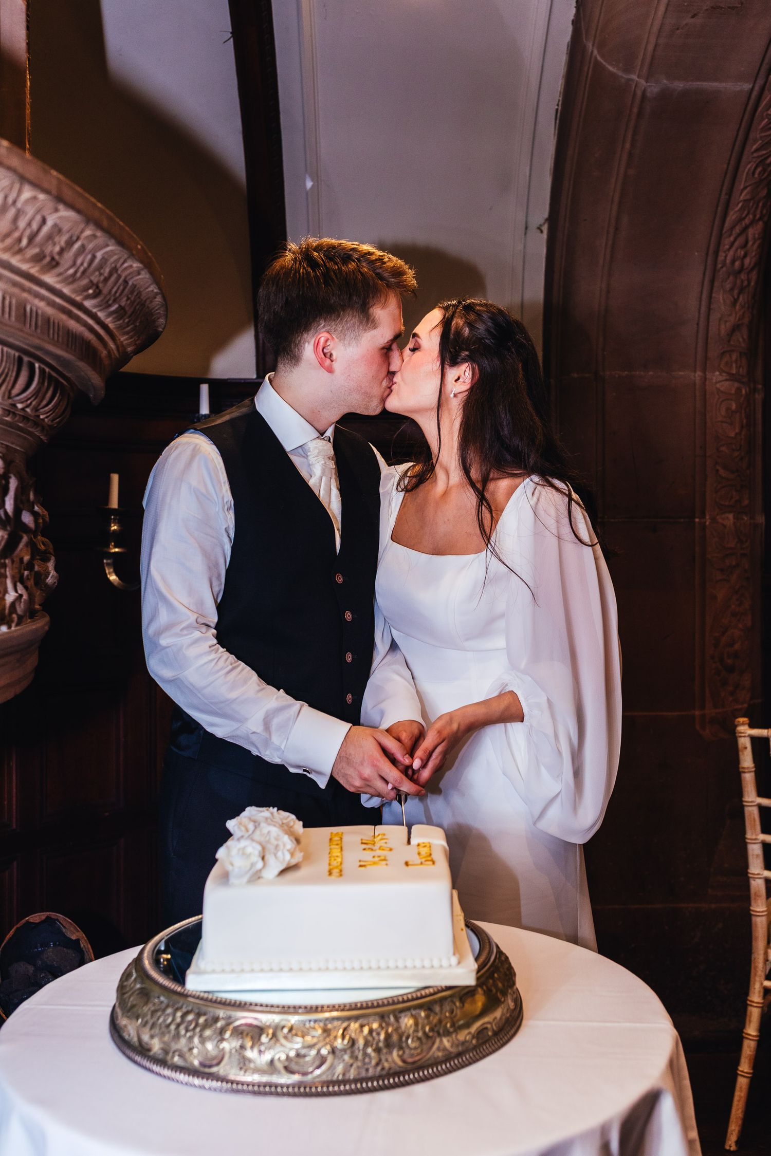 Couple cutting wedding cake at Netherwood Hotel and Spa, Lake District reception photography