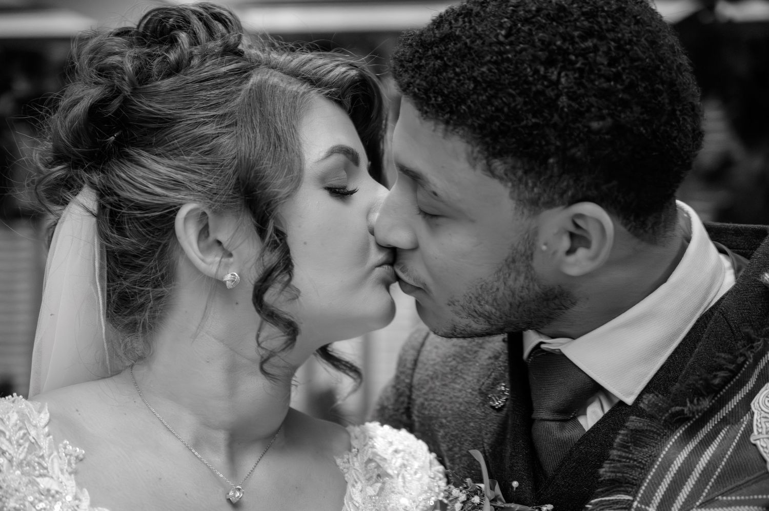 Black and white photo montage showing three intimate romantic moments between a couple sharing tender kisses. Busby Hotel.