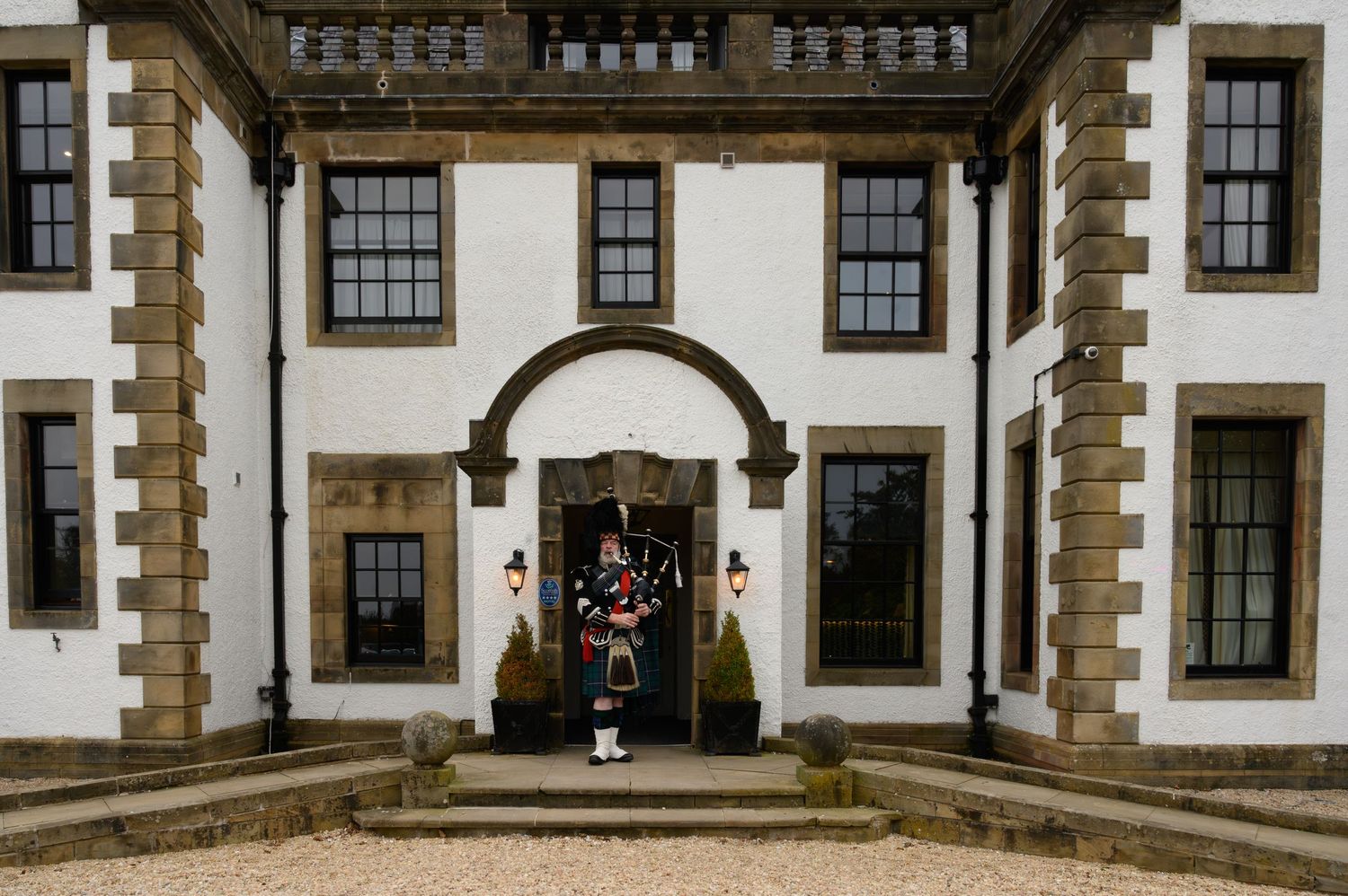 A bagpiper performs at the entrance of Gleddoch Hotel and Spa.