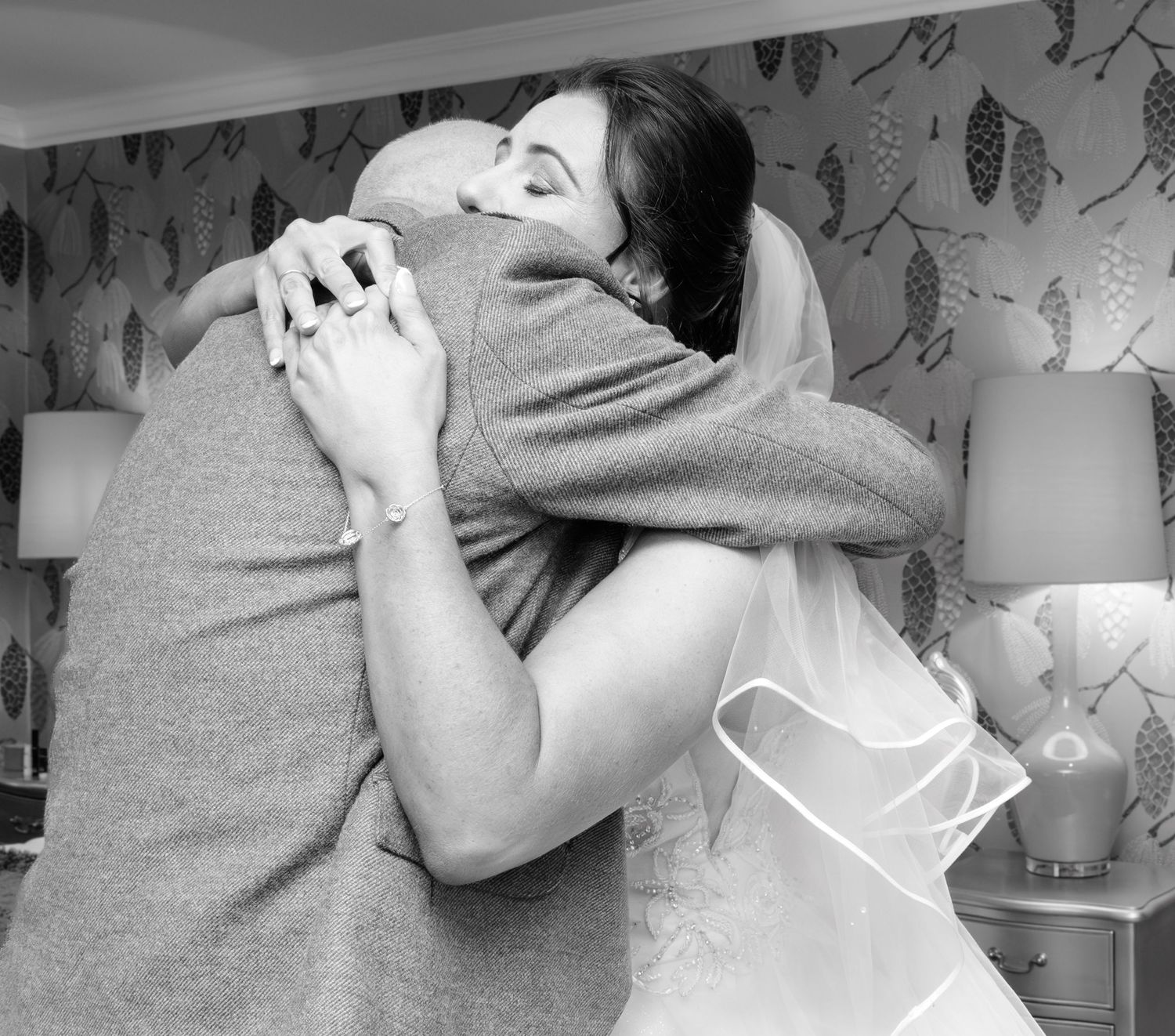 A series of black and white photos showing intimate close-up moments between father and daughter in an affectionate embrace. Gleddoch.