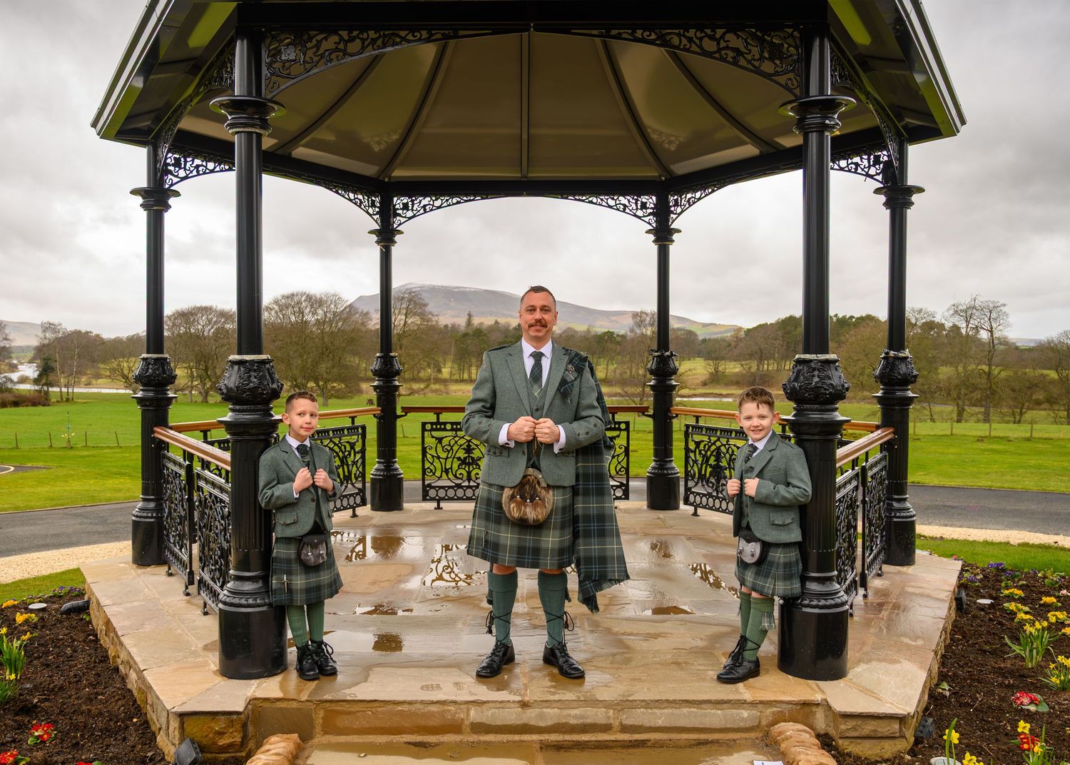 A panoramic sequence of shots showing a gazebo in a park with ornate Victorian-style architecture and green surroundings.