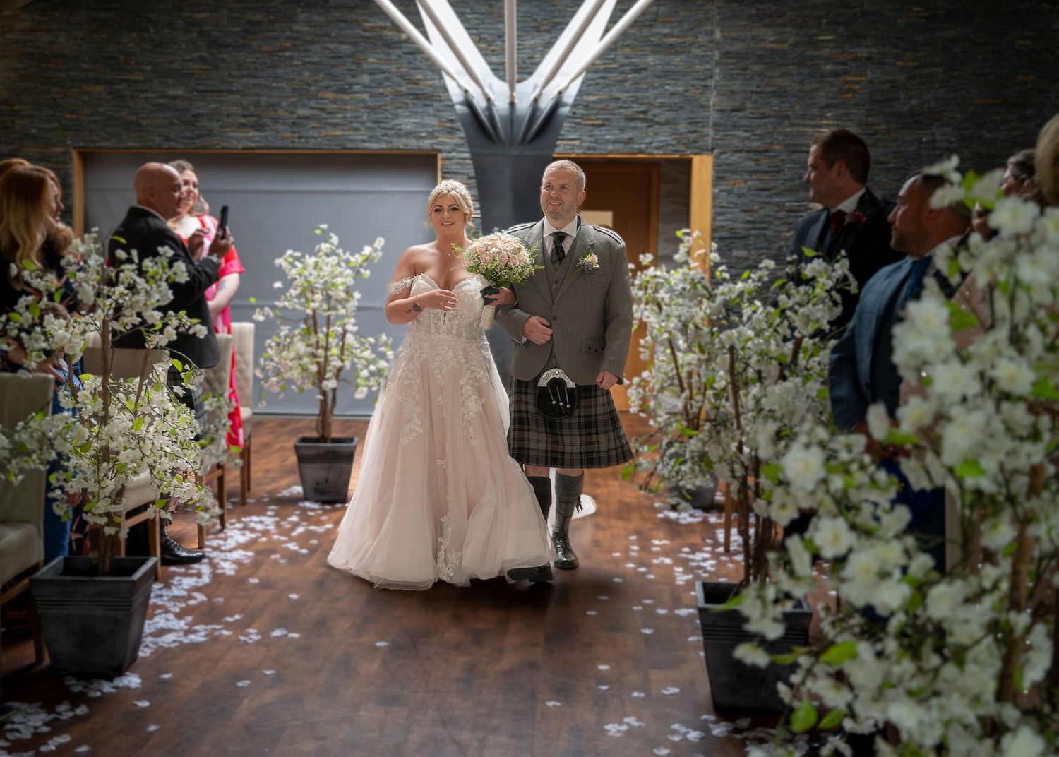 Father and daughter walking up the  aisle at The Vu in Bathgate.