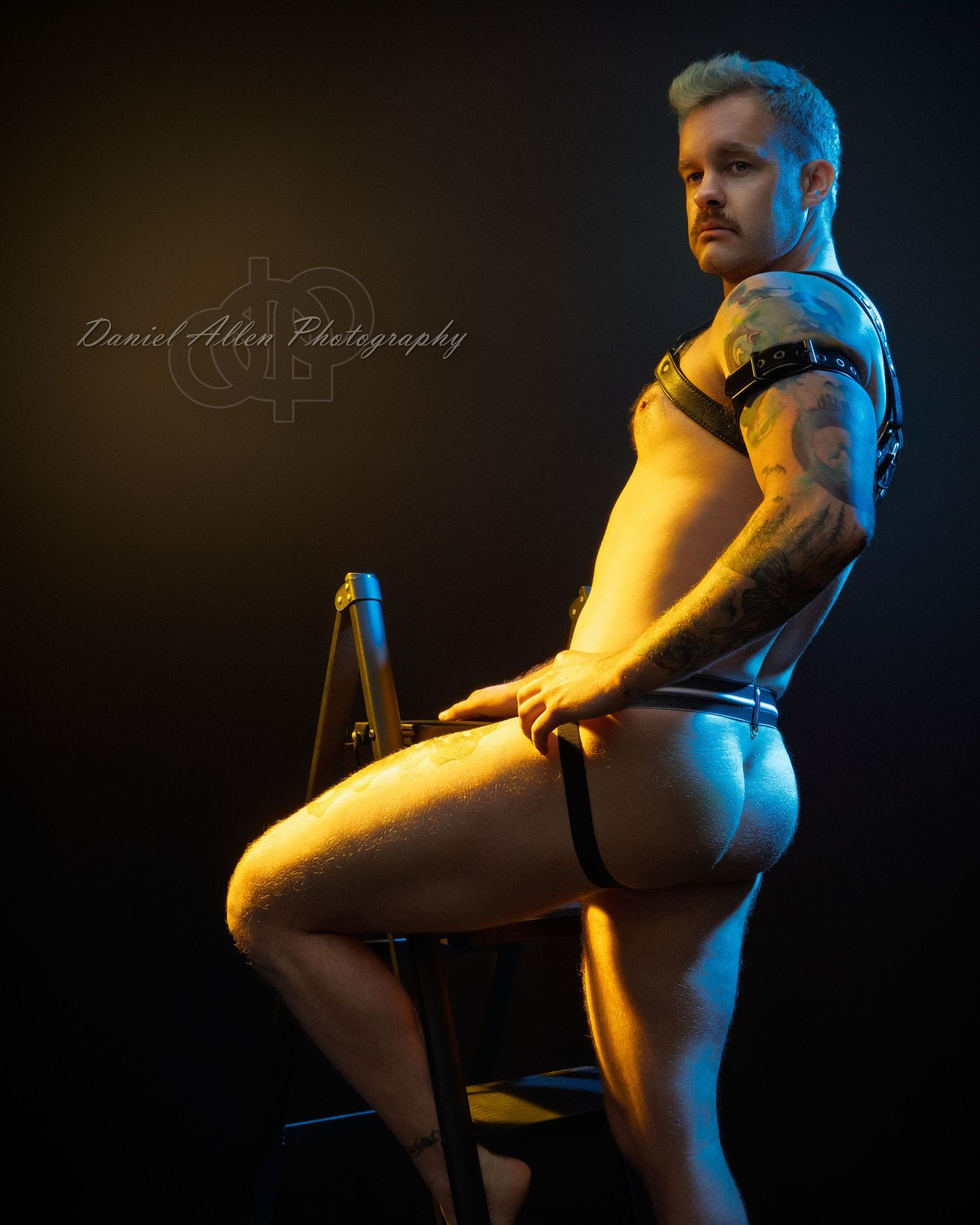 Dramatic portrait series with contrasting yellow and blue lighting creates moody silhouettes against dark background.
