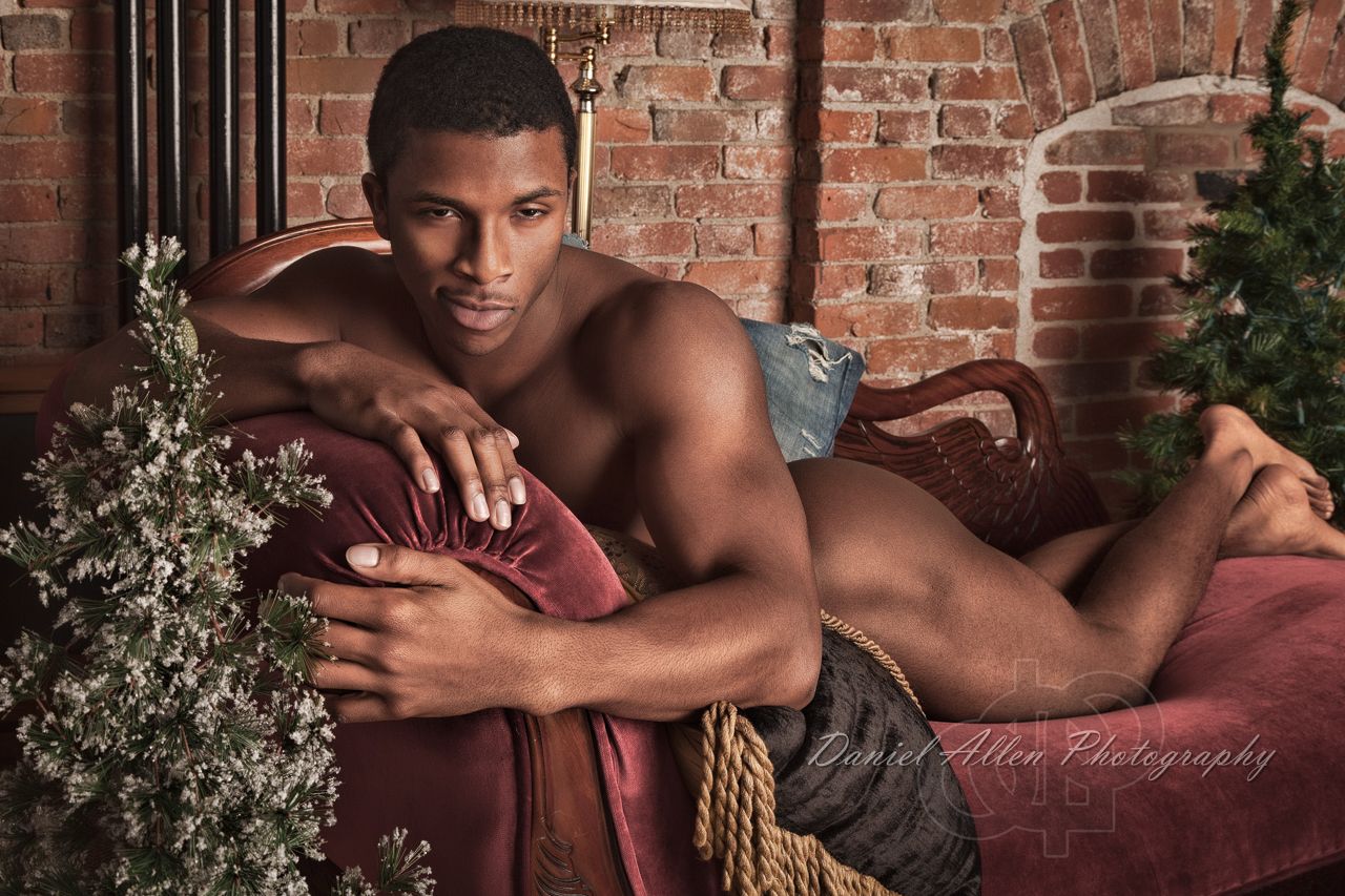 Intimate portrait session against exposed brick wall background.