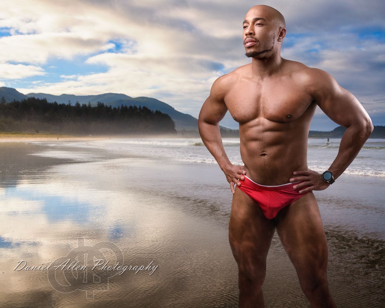 Beachside photography with dramatic clouds and mountains in the background.