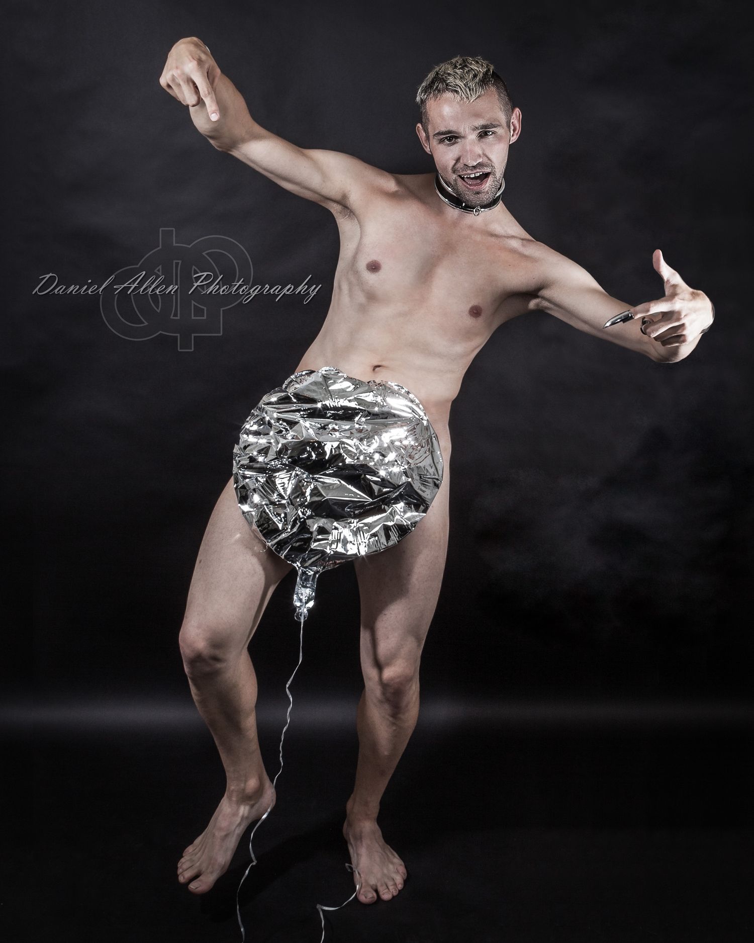 Monochromatic studio sequence showing dance-like movements with metallic fabric effects.