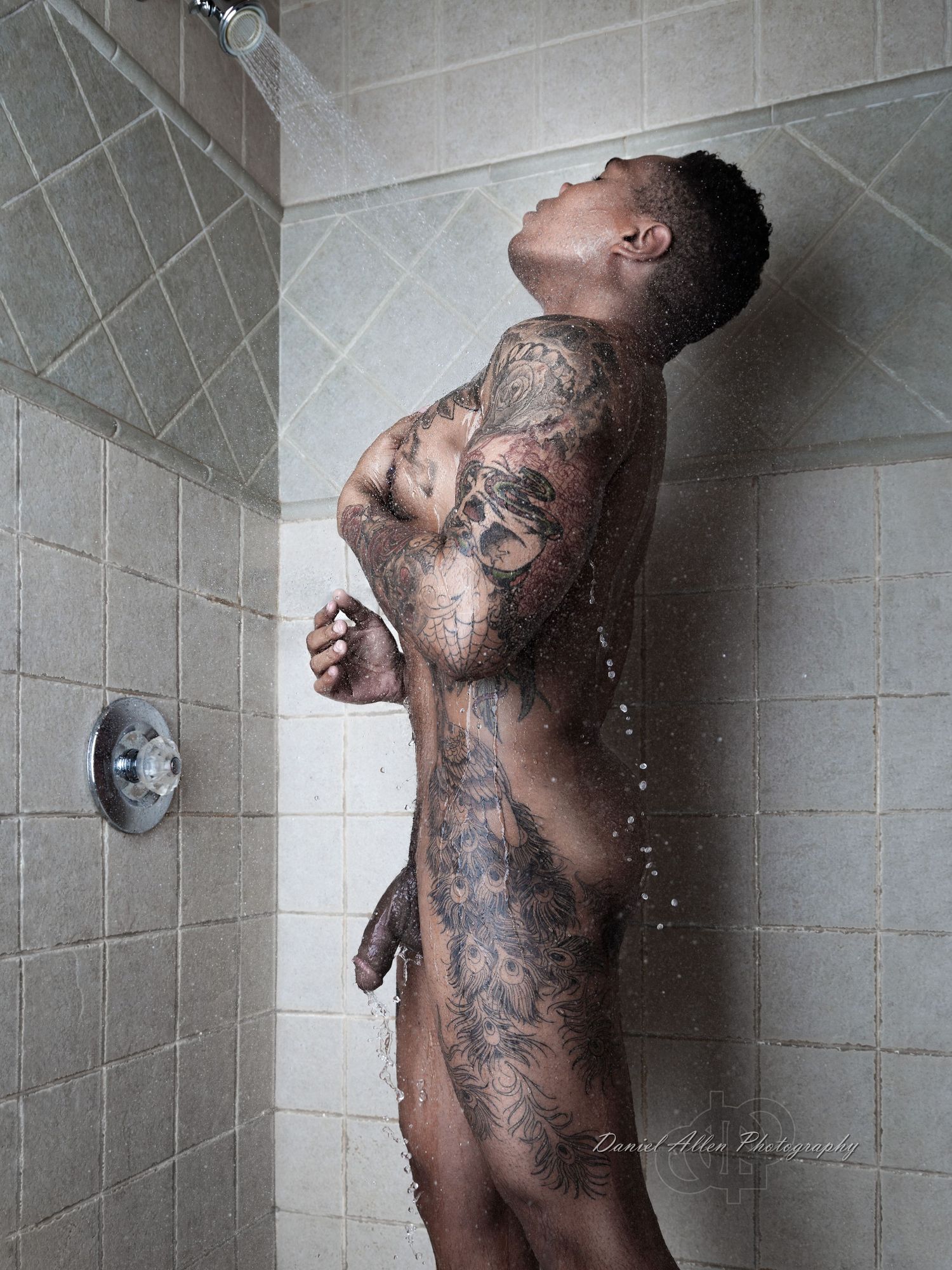A series of five black and white shower photos showing a heavily tattooed figure with water cascading down.
