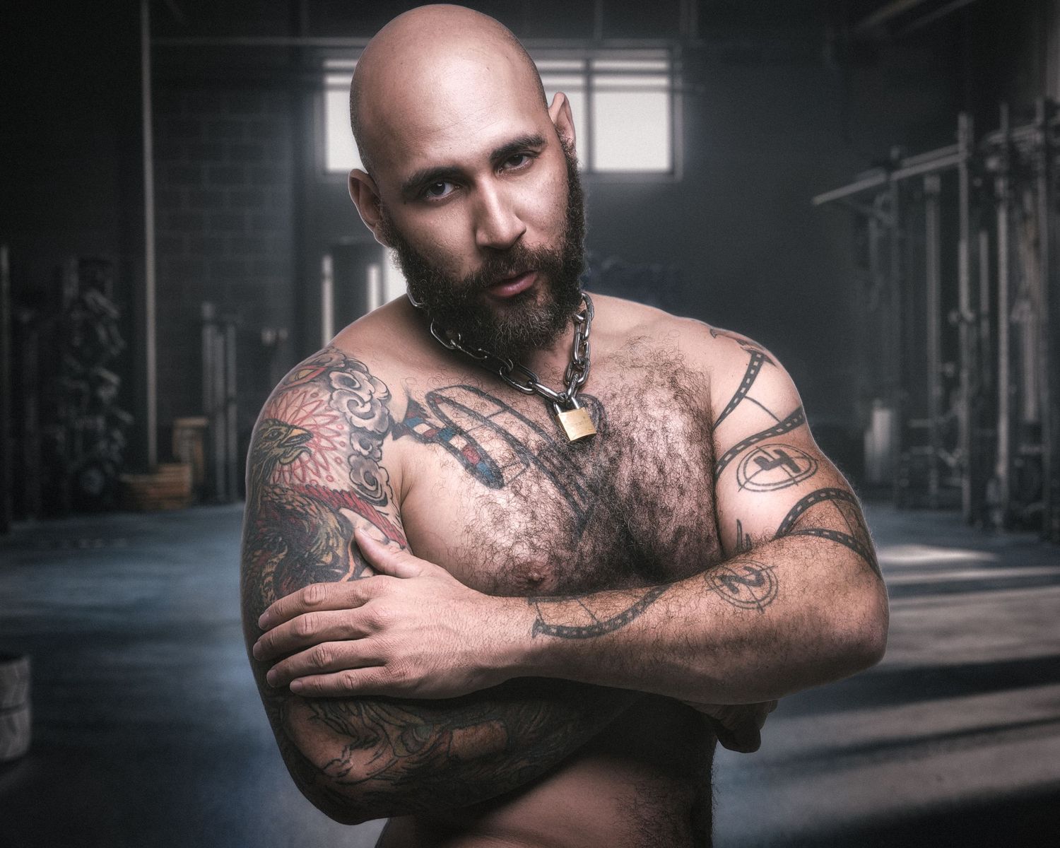 A dramatic black and white photo series showing muscular tattooed arms crossed in different poses against a dark background.