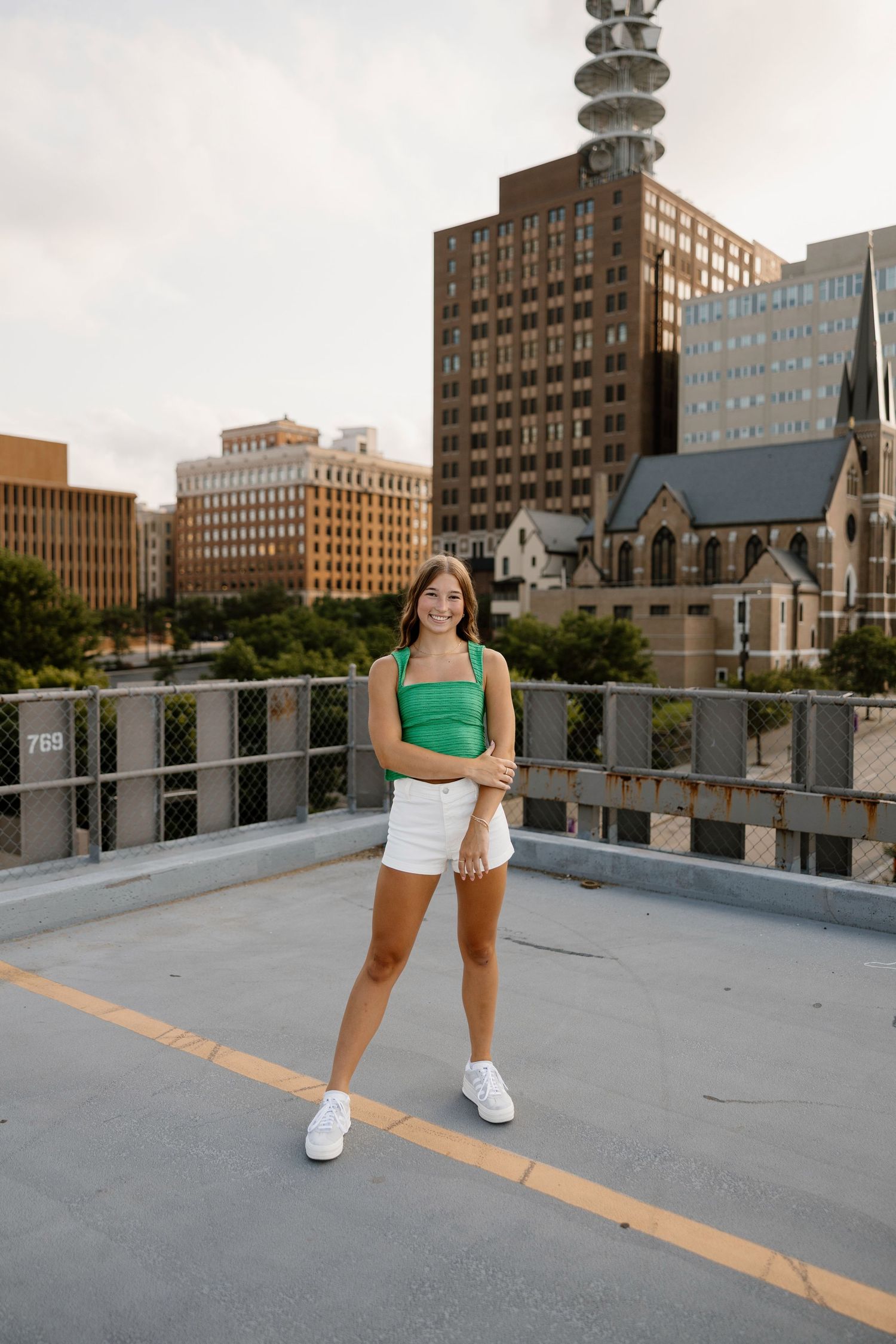 Rooftop photoshoot with downtown skyline and buildings visible in the background.