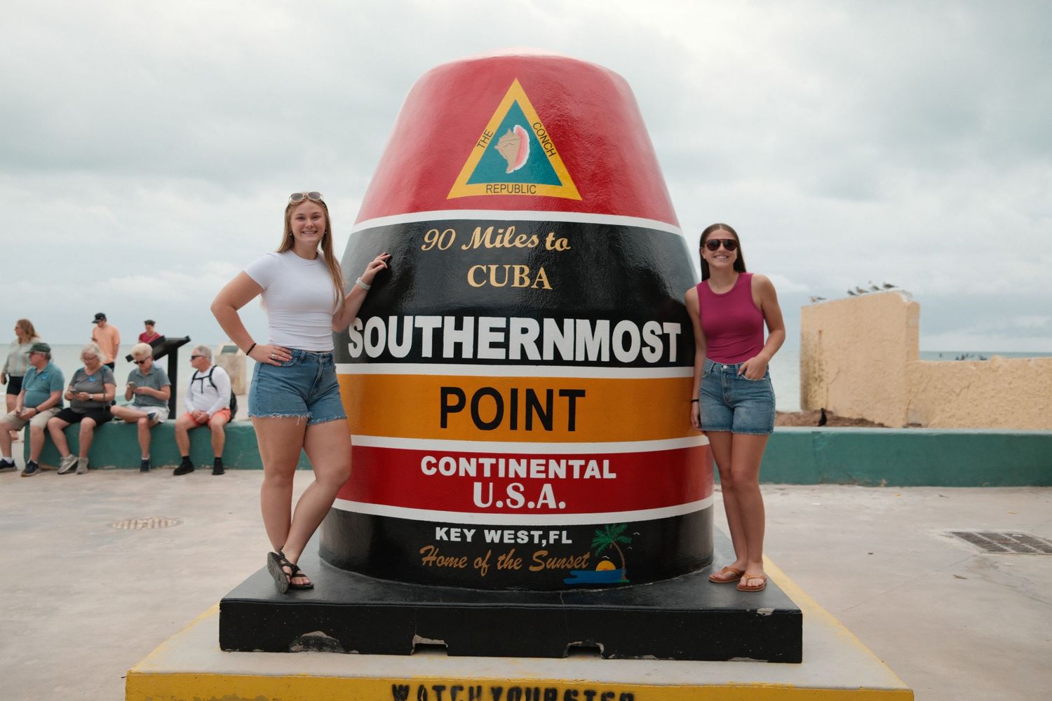 Collection of colorful buoy markers and signs at the Southernmost Point in Key West, Florida.