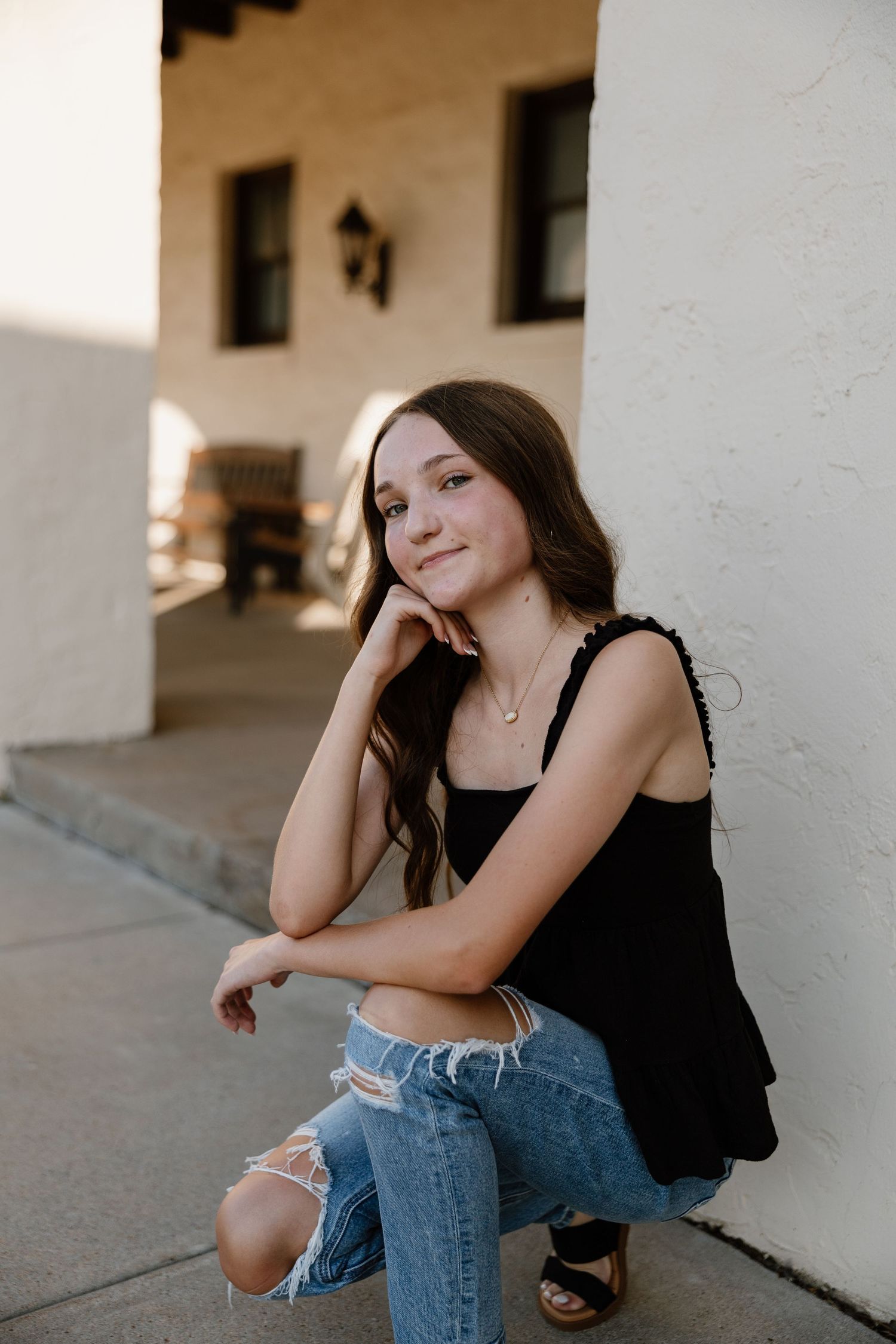 Artistic portrait series along a white colonnade with natural lighting.