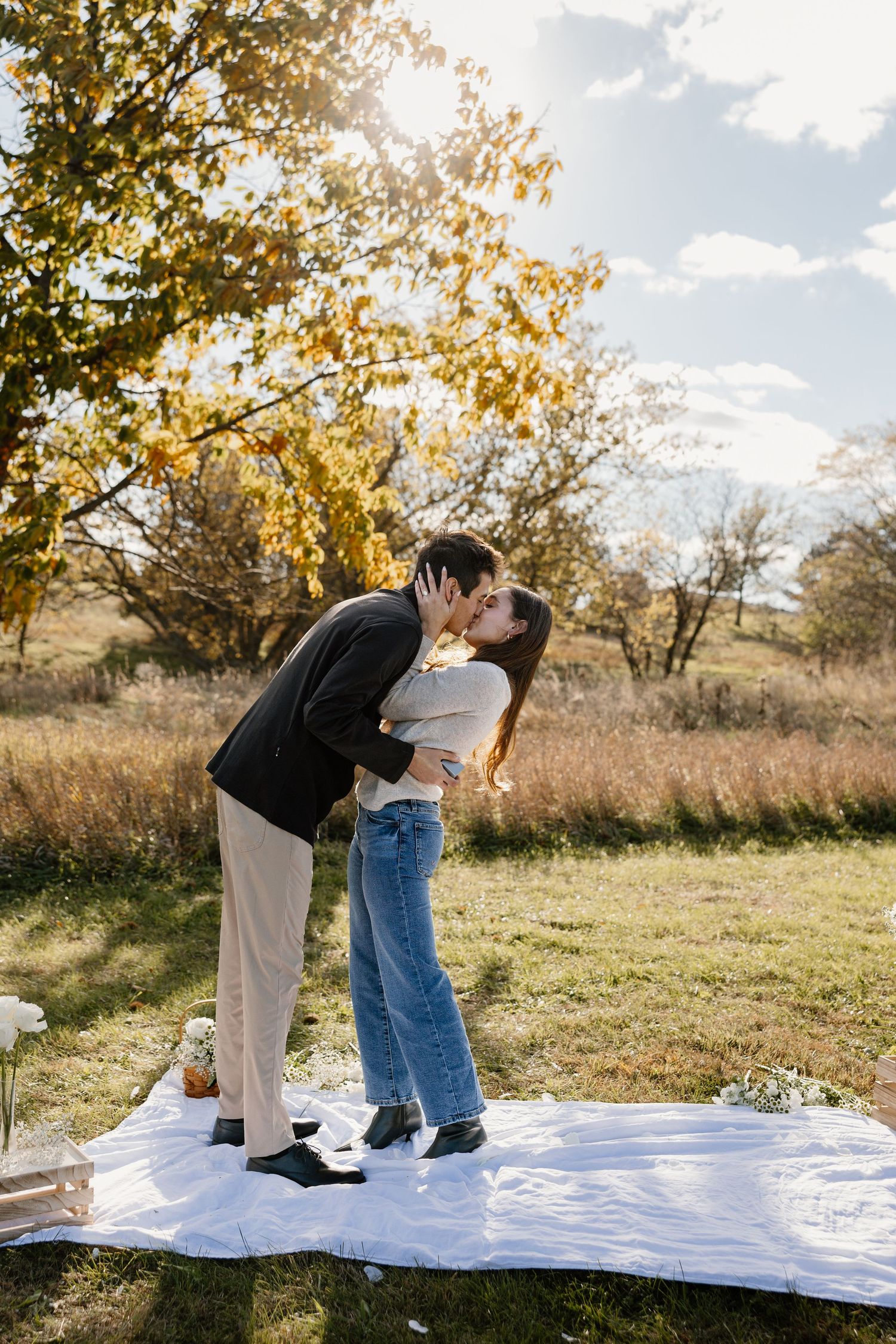 Emotional proposal sequence captured on a white blanket in a fall landscape.