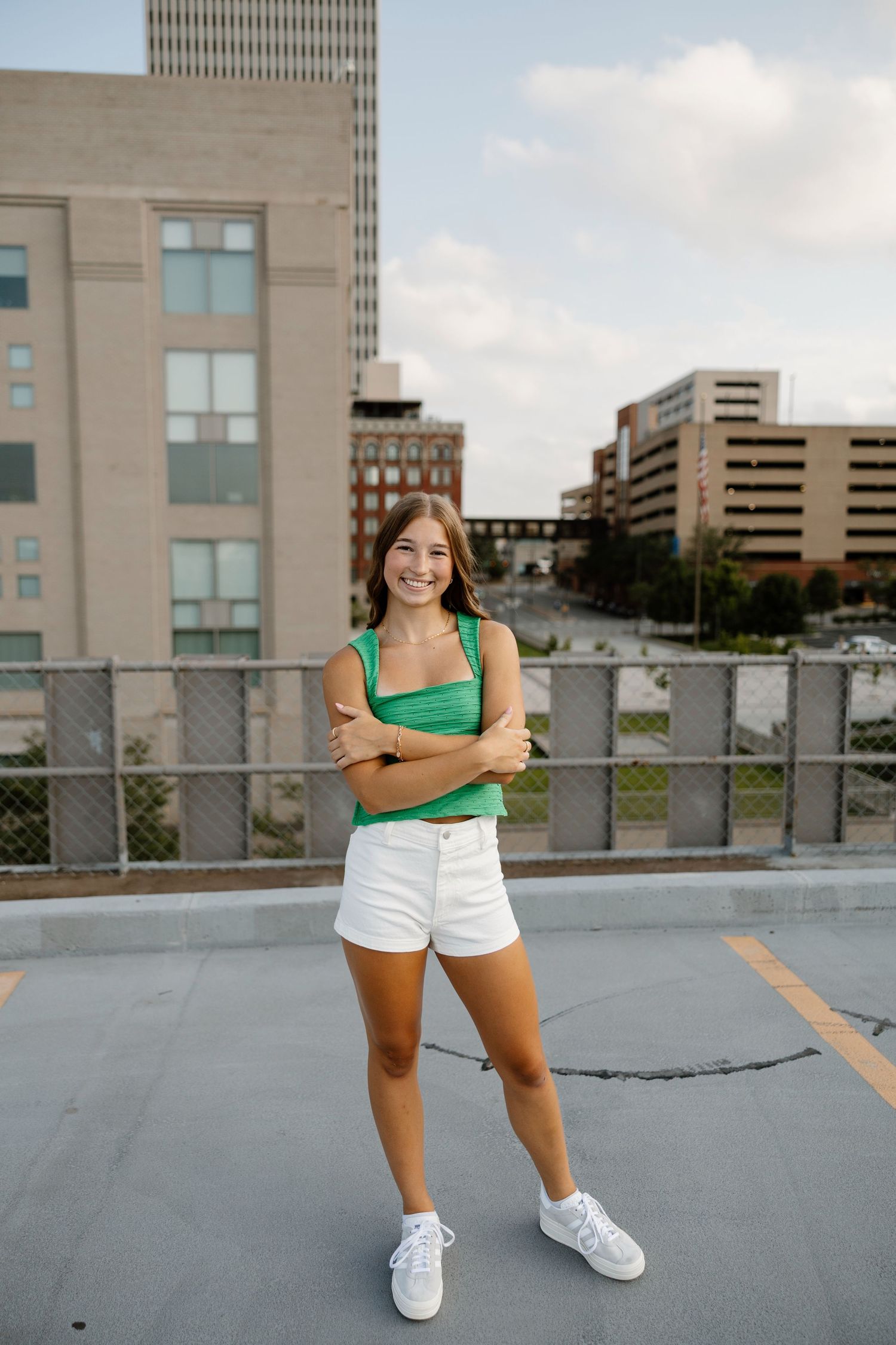 Athletic photo shoot on an urban rooftop with city buildings in the background.