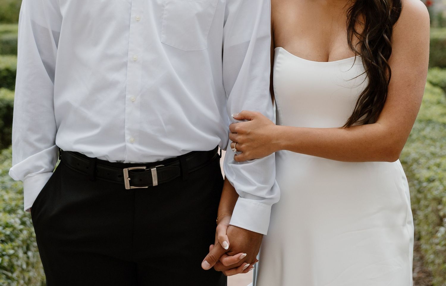 Couple in coordinated black and white outfits pose together during outdoor photo session.