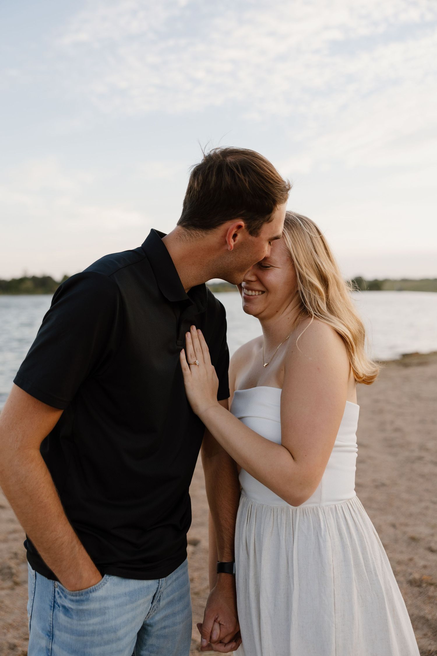 Intimate couple portraits captured during a beach engagement session at sunset.