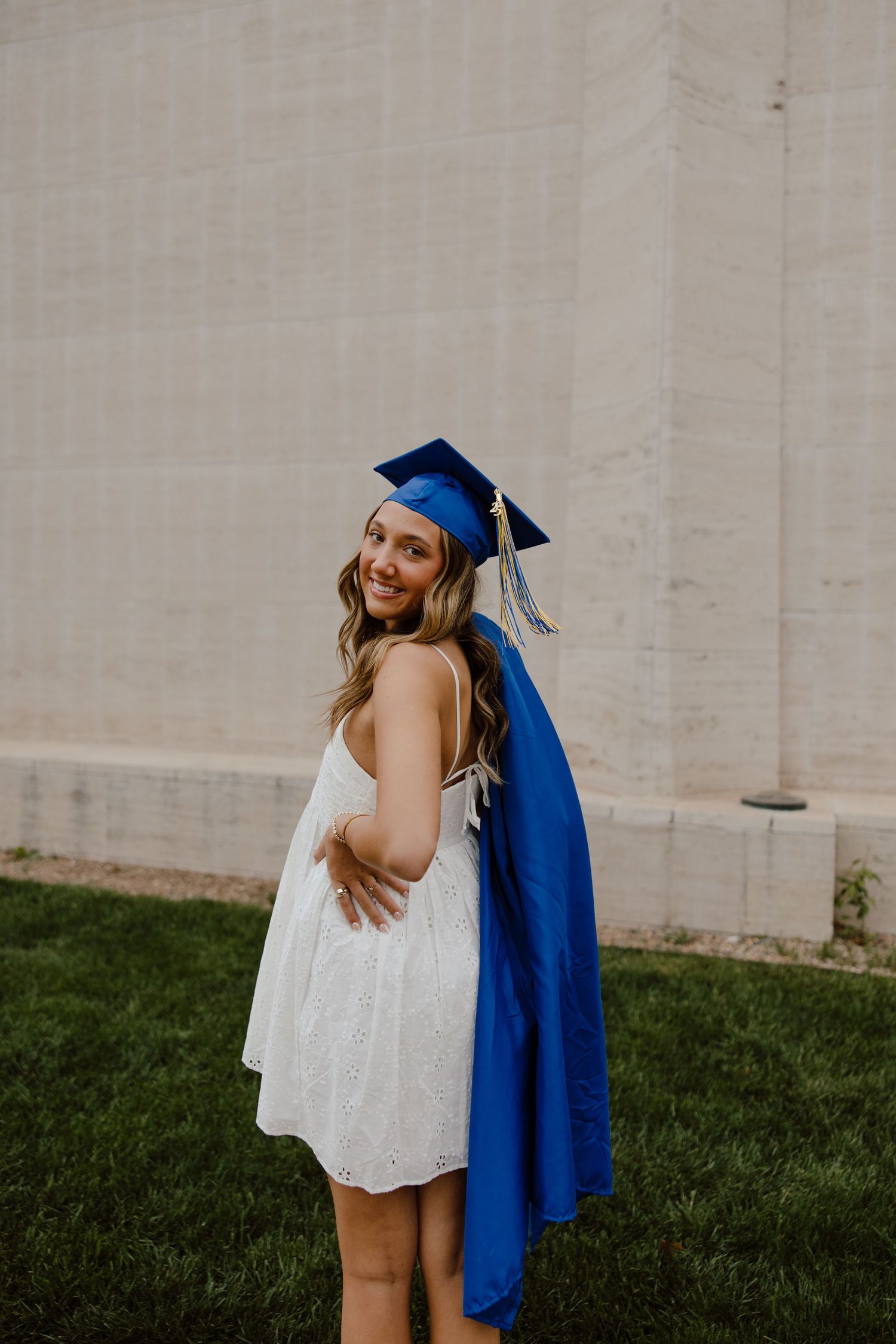 Series of graduation photos showing blue cap and gown with white dress.