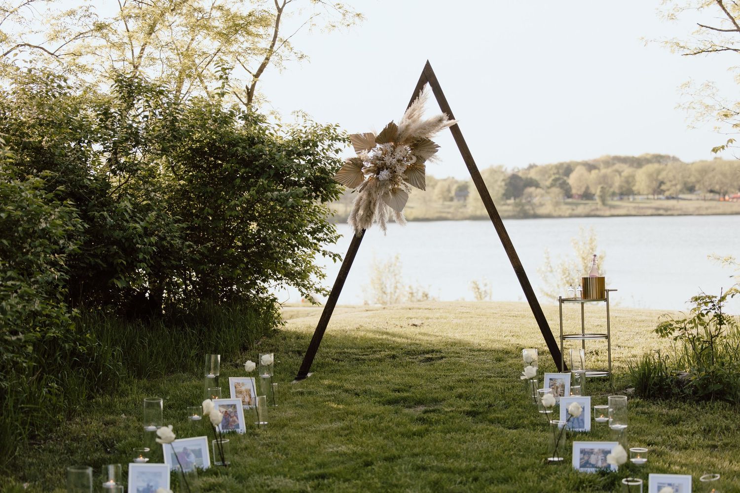 A decorated outdoor proposal setup with lanterns and flowers at dusk.