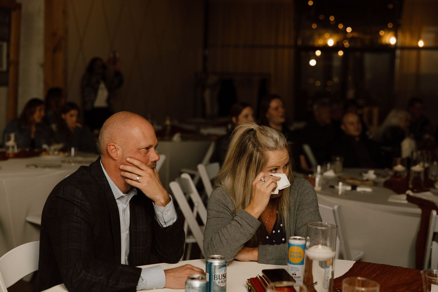 Couple at dinner table showing emotions of disappointment or distress during meal at restaurant.