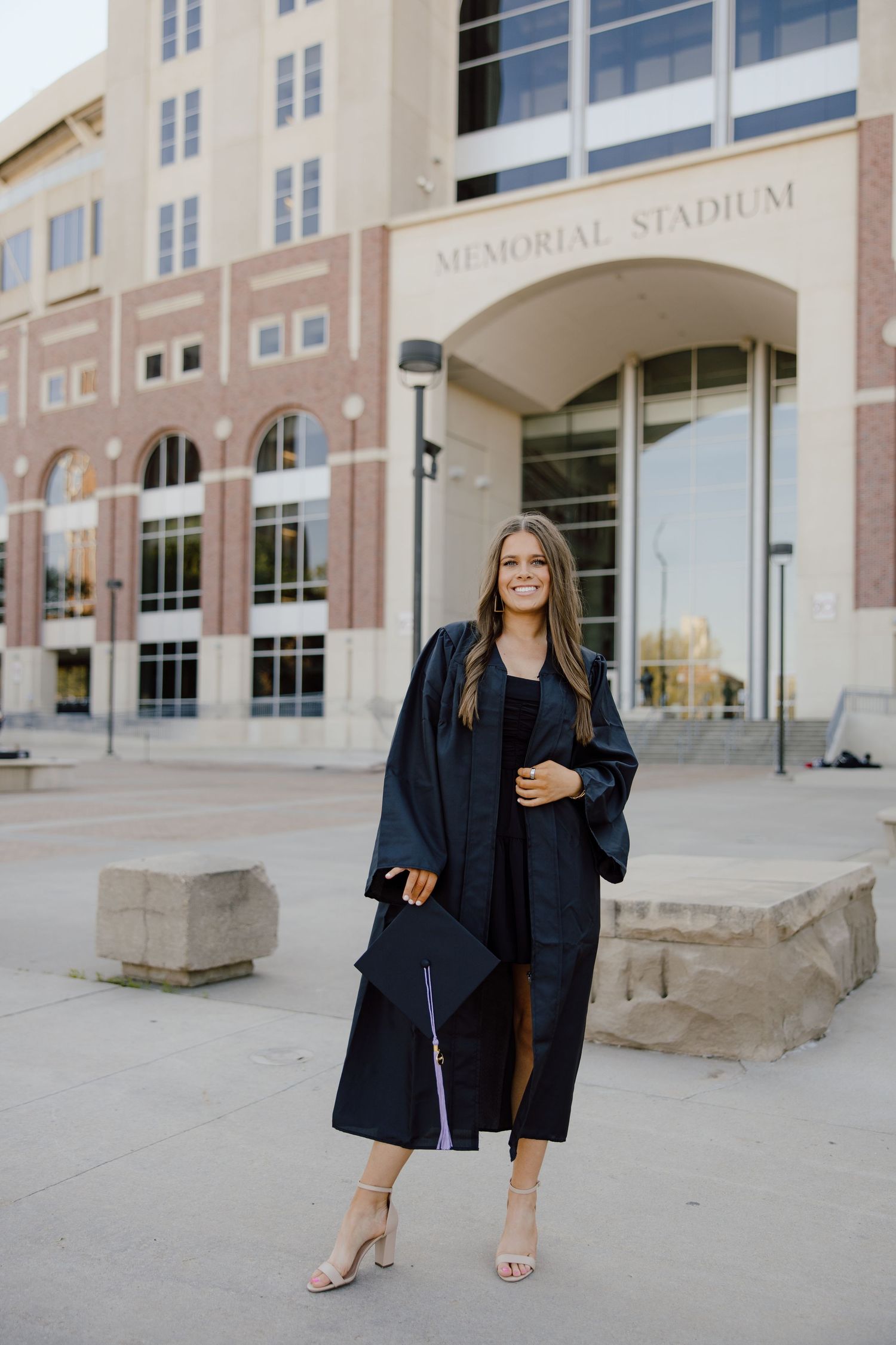 Professional graduation photos in front of Memorial Stadium entrance.