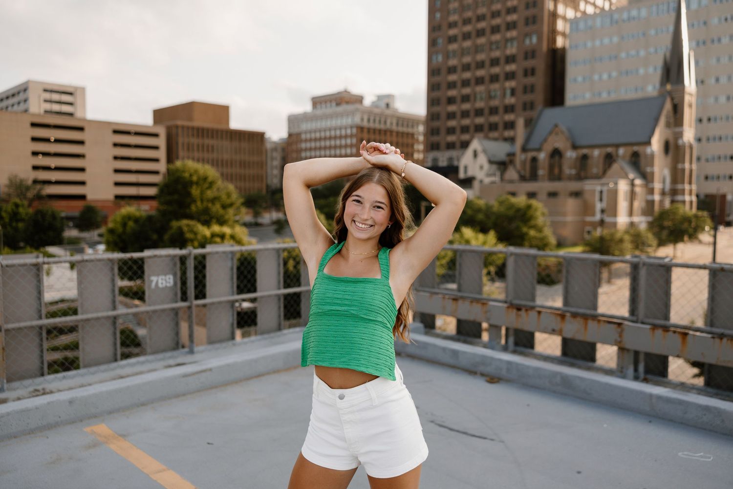 Urban rooftop setting with city buildings and architecture in the background.