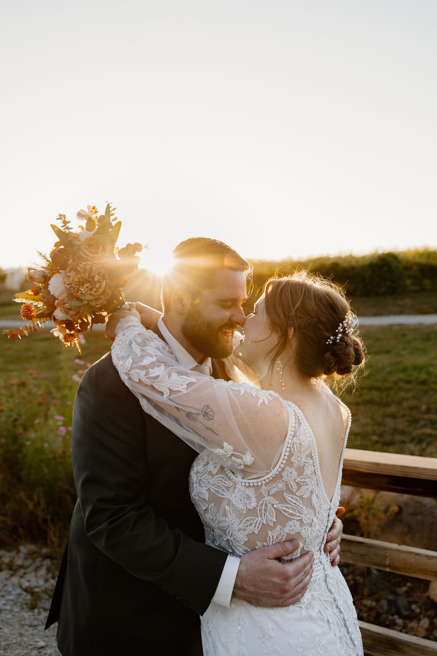 Romantic sunset wedding photos with couple embracing in golden light.