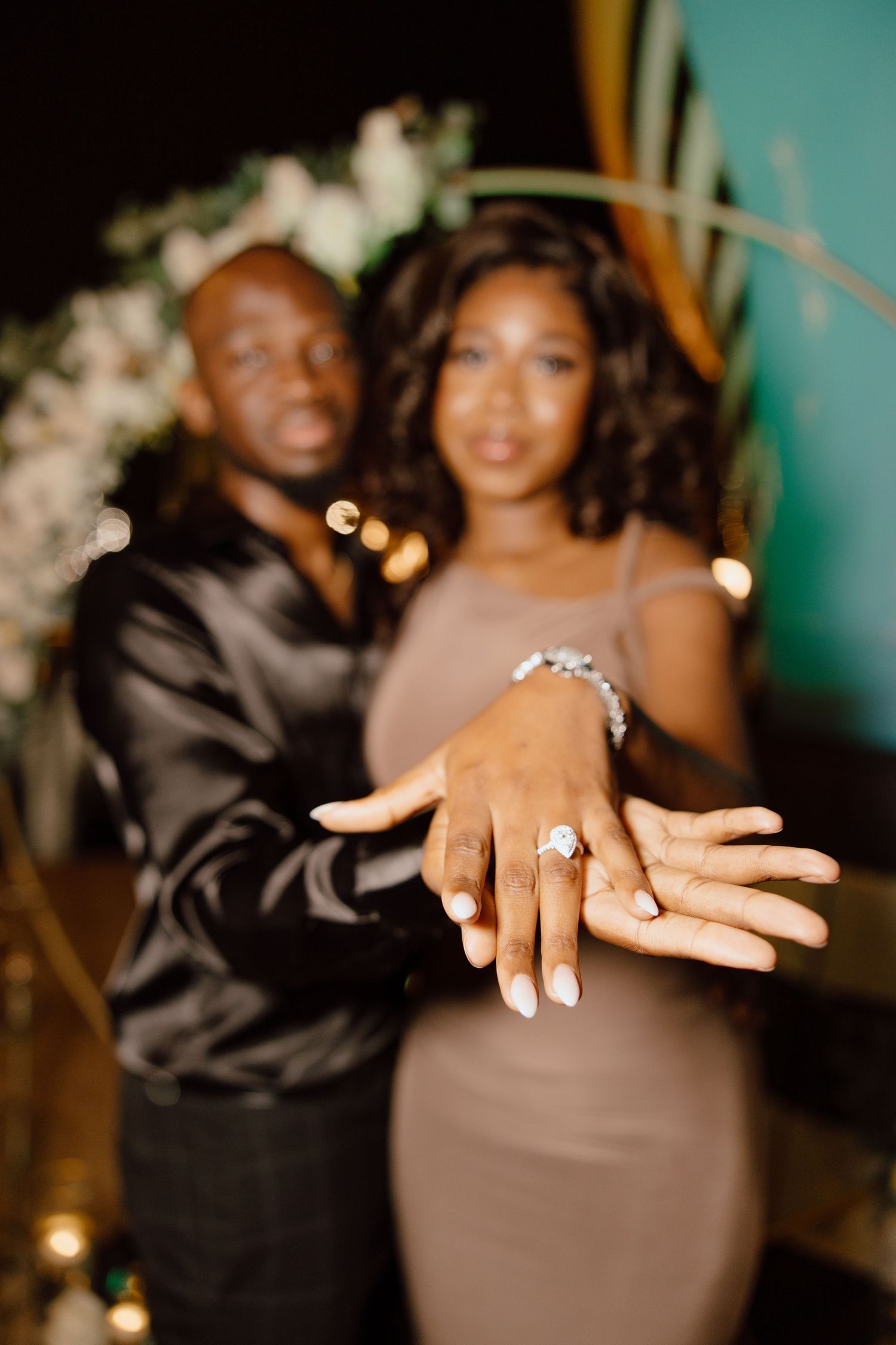 Close-up shots of hands showing off a sparkling engagement ring in a romantic proposal moment.