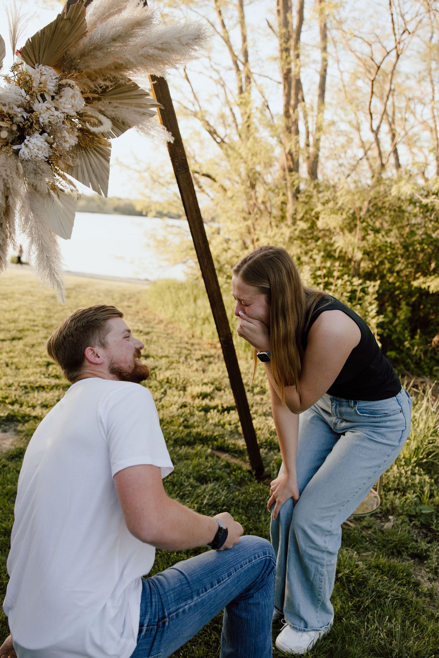 A surprise proposal captured in sequence photos outdoors during golden hour.