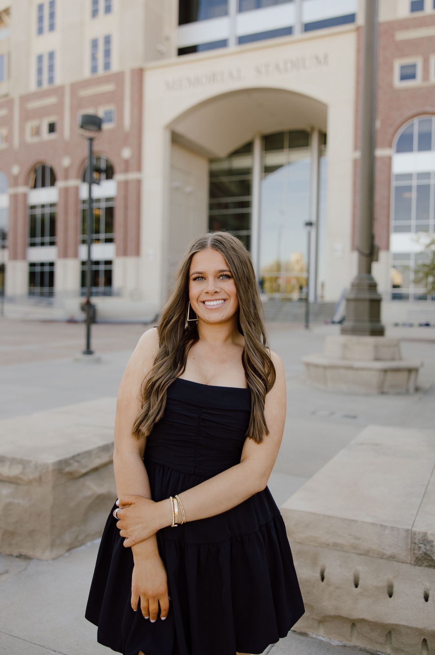 Fashion portraits taken outside Memorial Stadium with architectural backdrop.