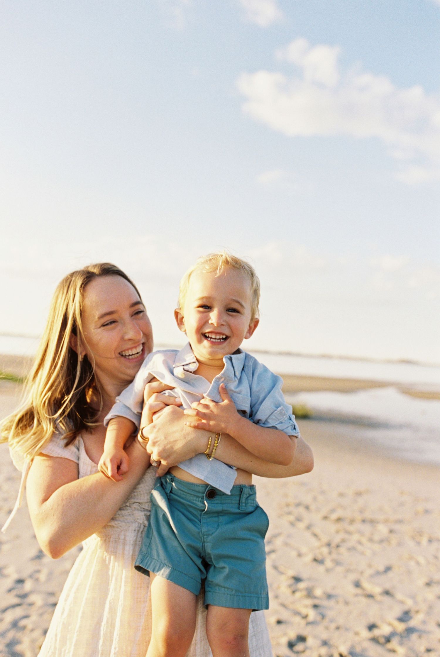A joyful family moment captured in a series of candid photos playing together on a sunny beach.