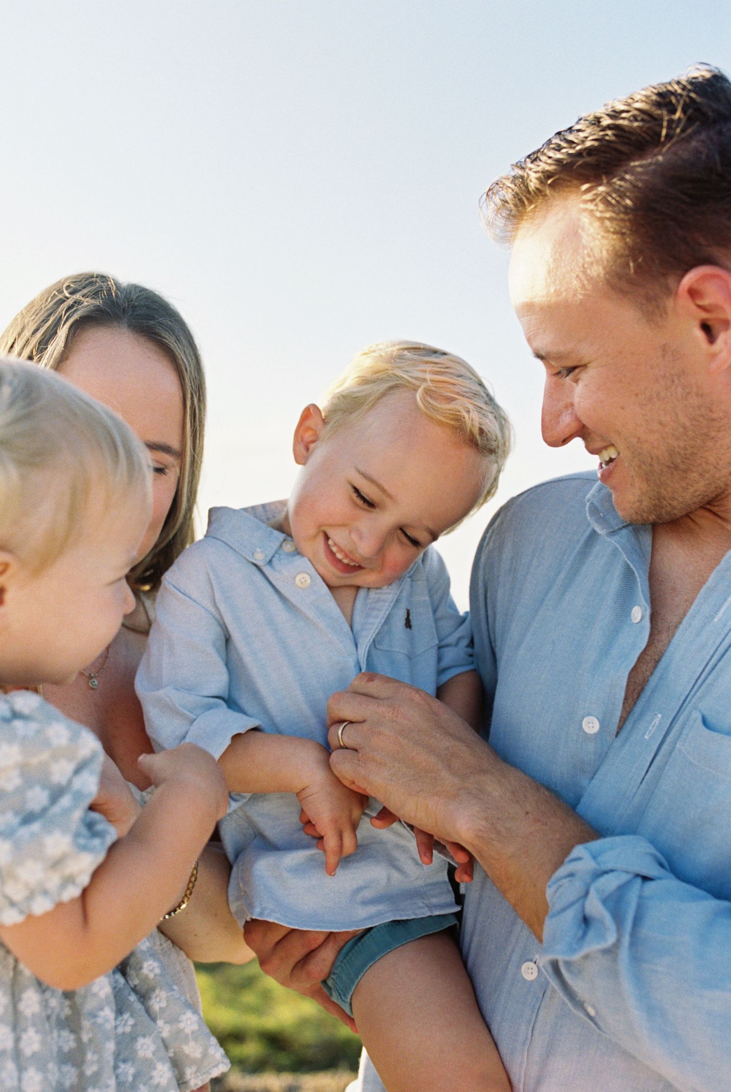Candid family moments captured in a series of tender interactions on a sunny day.