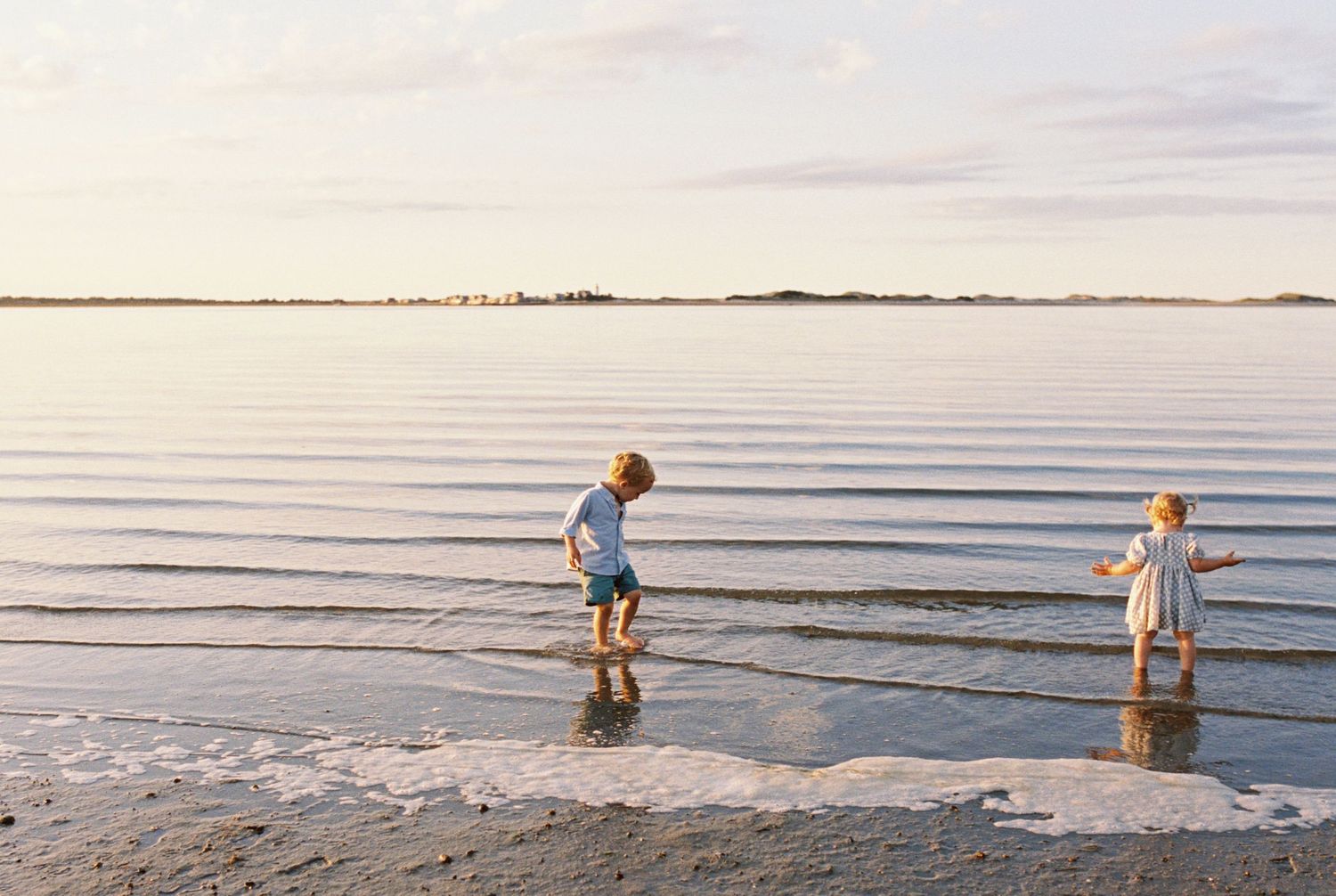 Multiple views of figures walking through shallow ocean waters at dusk with a peaceful horizon.