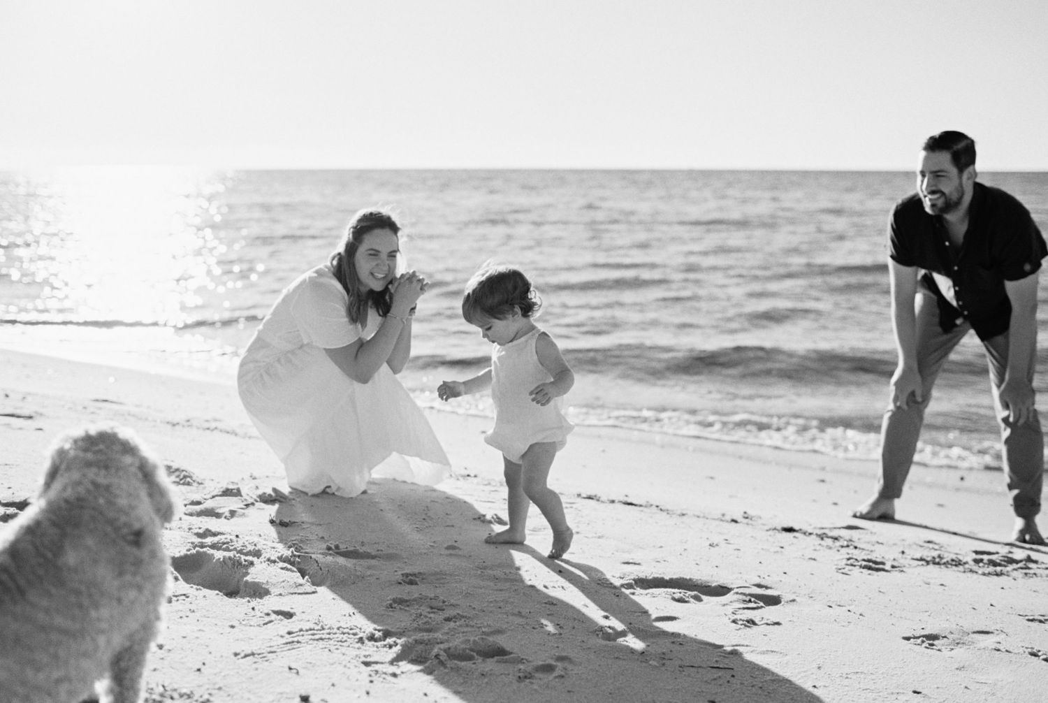 Playful beach moments captured in black and white photography.