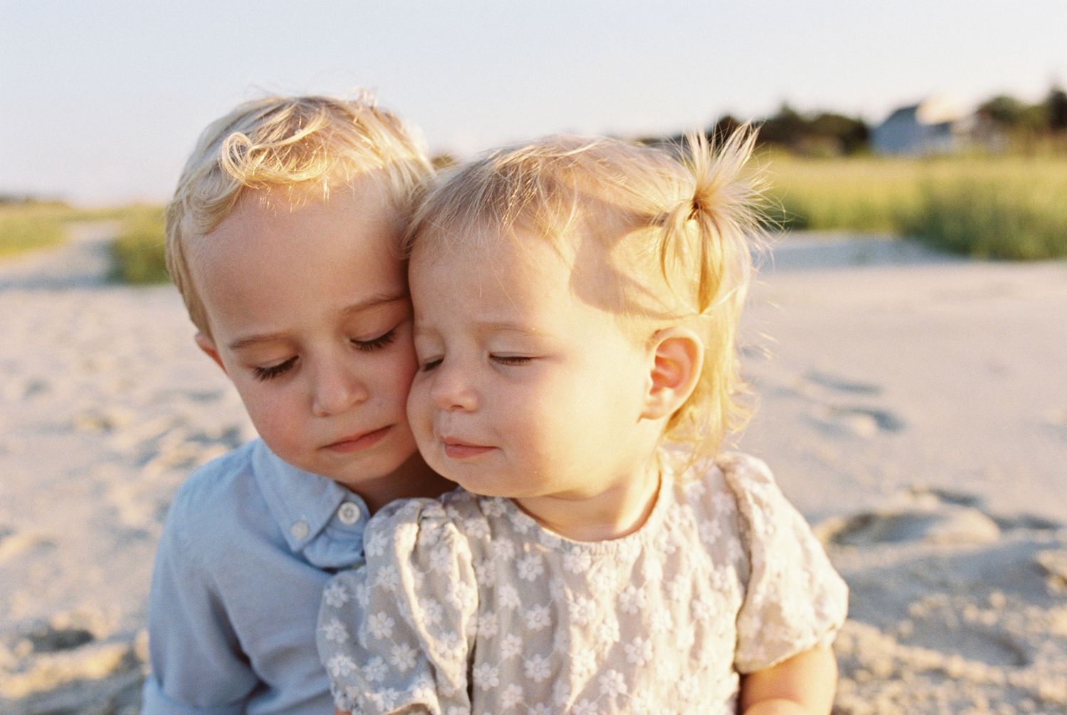 Tender family moment captured during sunset beach photoshoot.