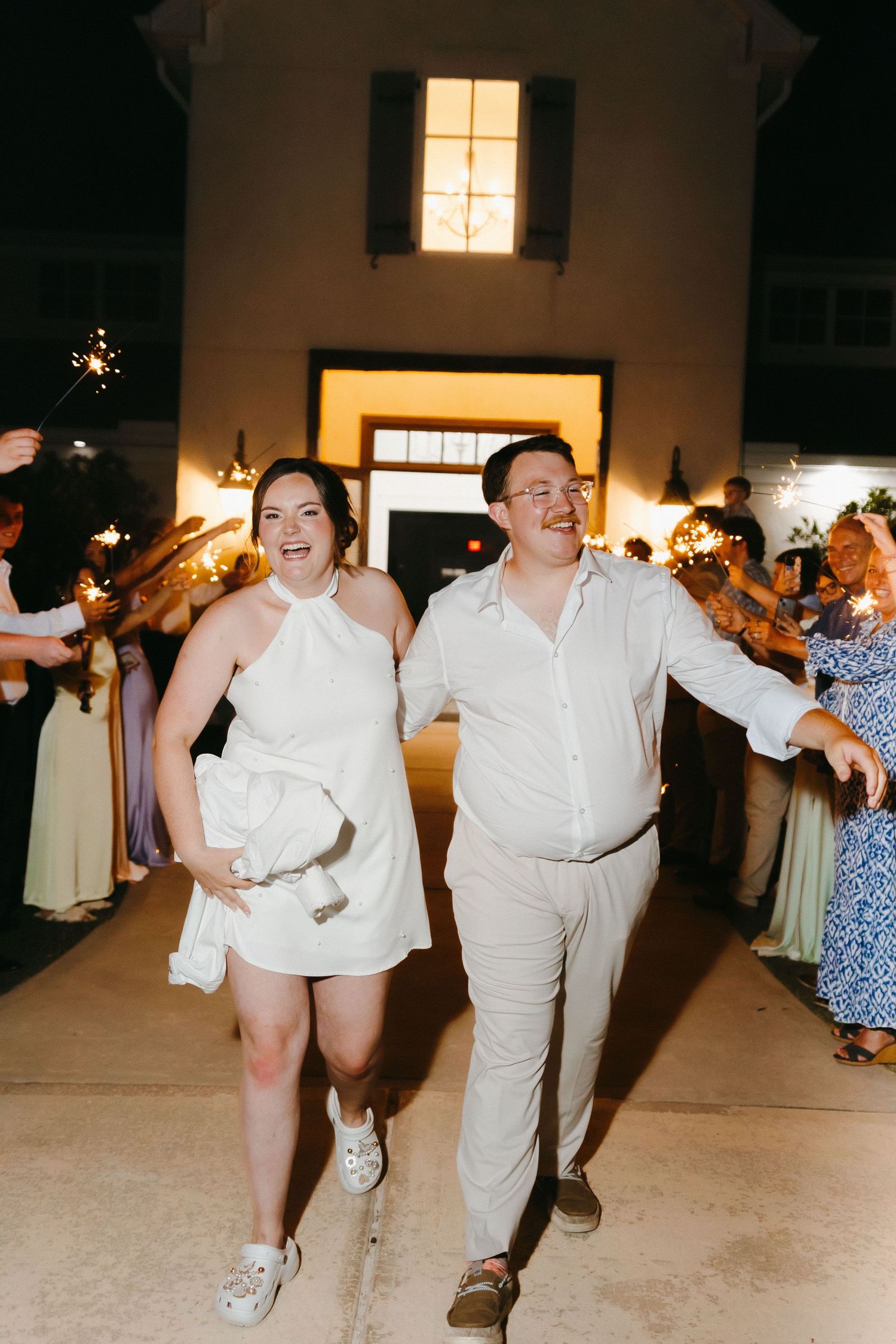 Wedding party dances and celebrates energetically in reception venue. Commerce, Georgia wedding photographer.