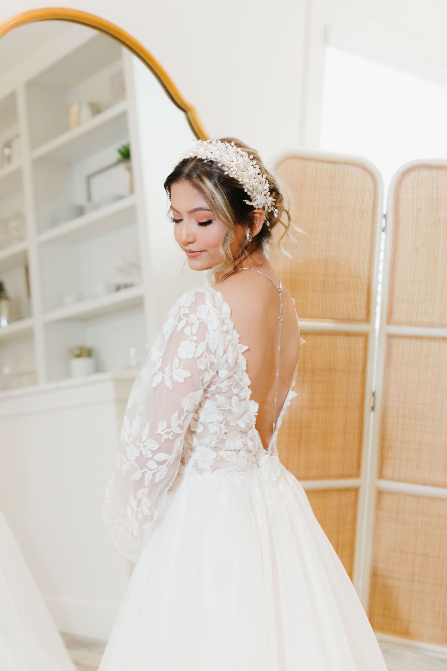 Delicate lace wedding gown with sheer sleeves and open back design. Wedding photographer in Cumming, Georgia.