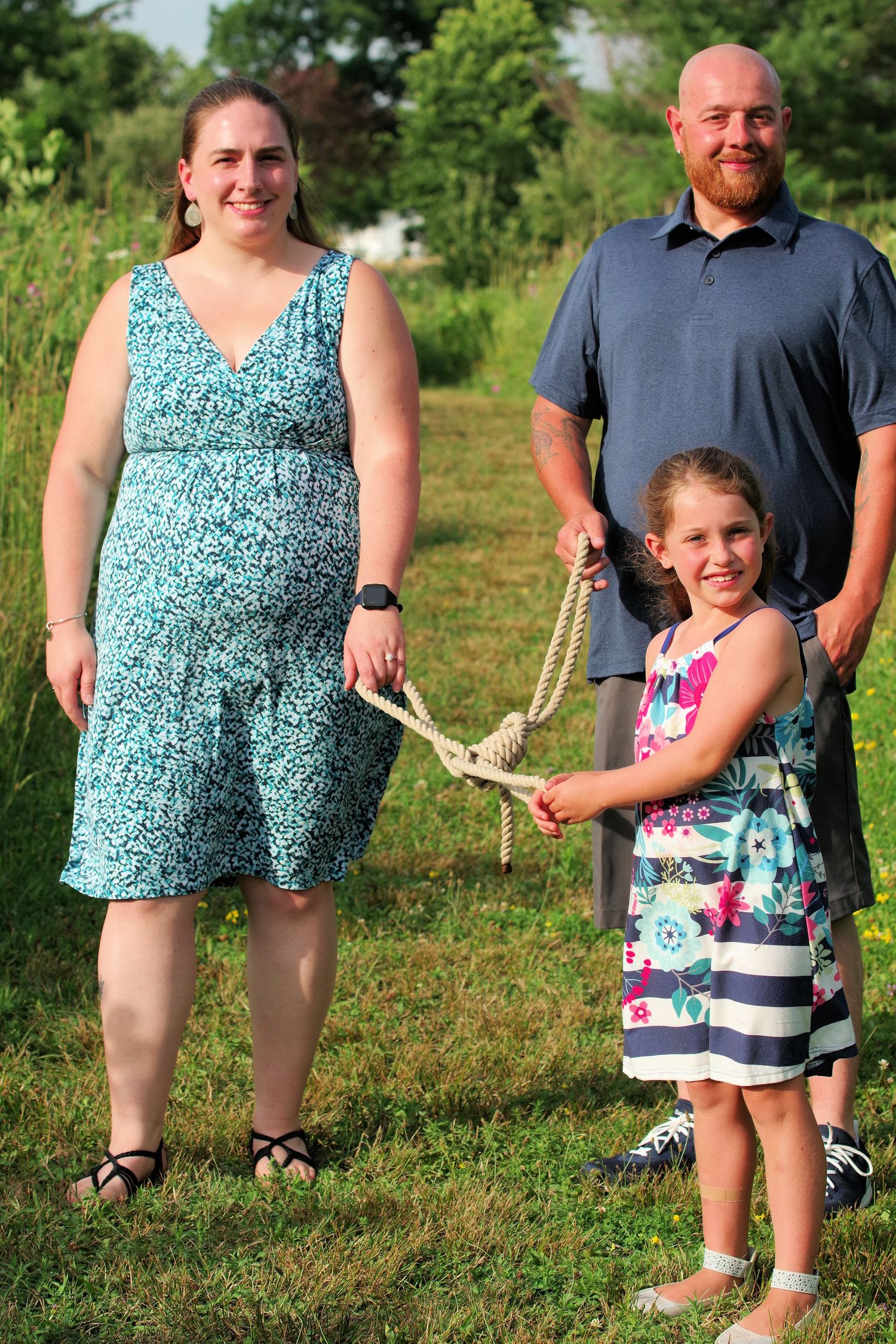 Family portrait in an outdoor nature setting during summer.