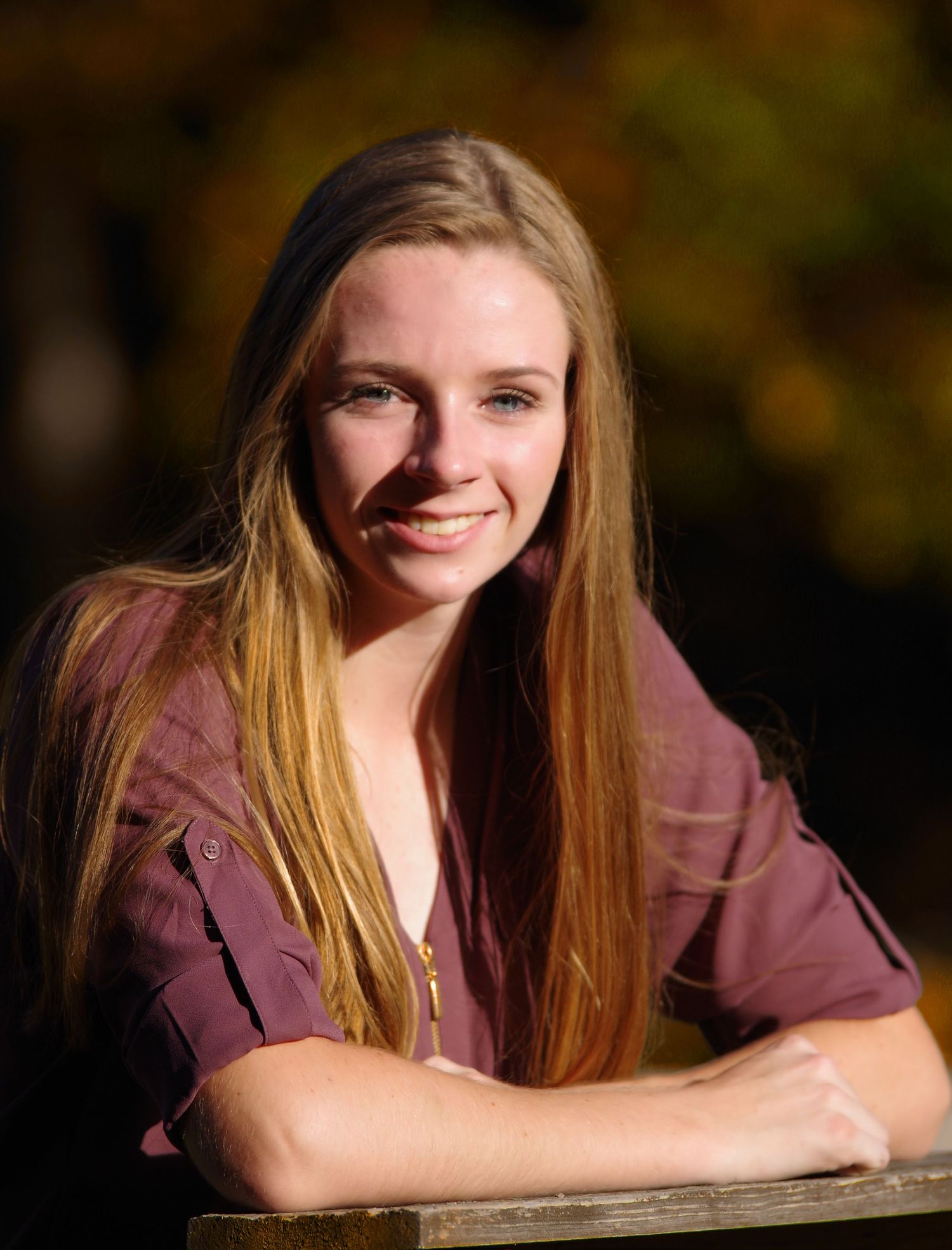 Relaxed portrait with soft lighting and warm autumn tones.