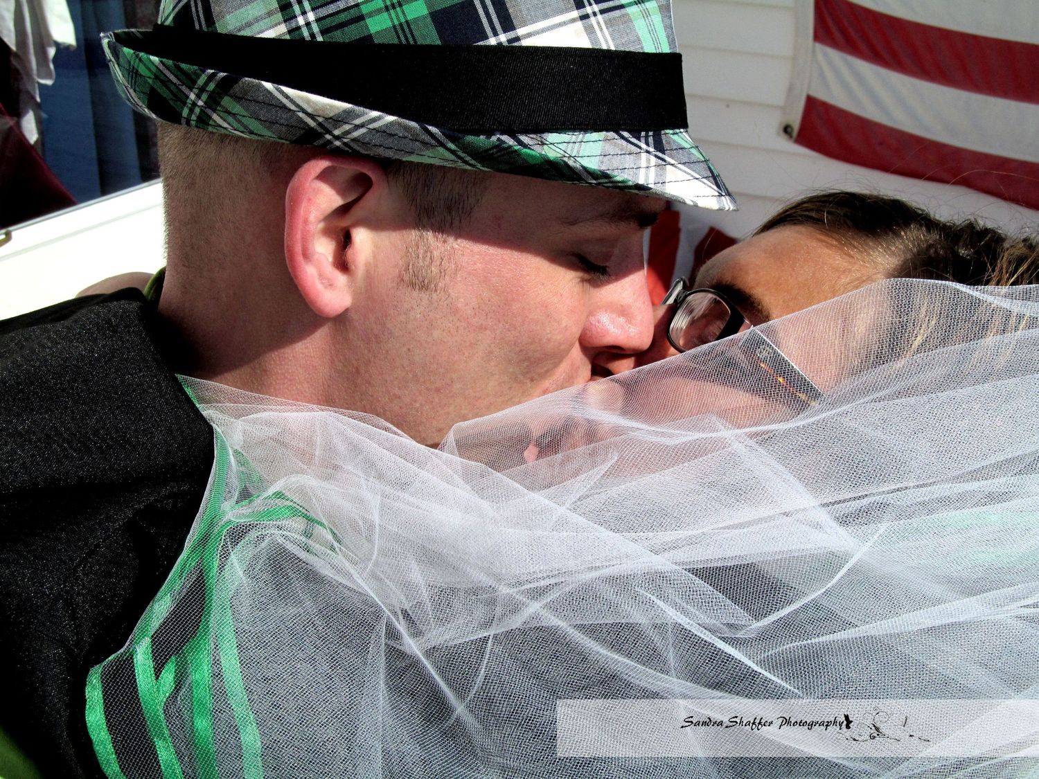 Black and white artistic wedding photograph with veil detail.