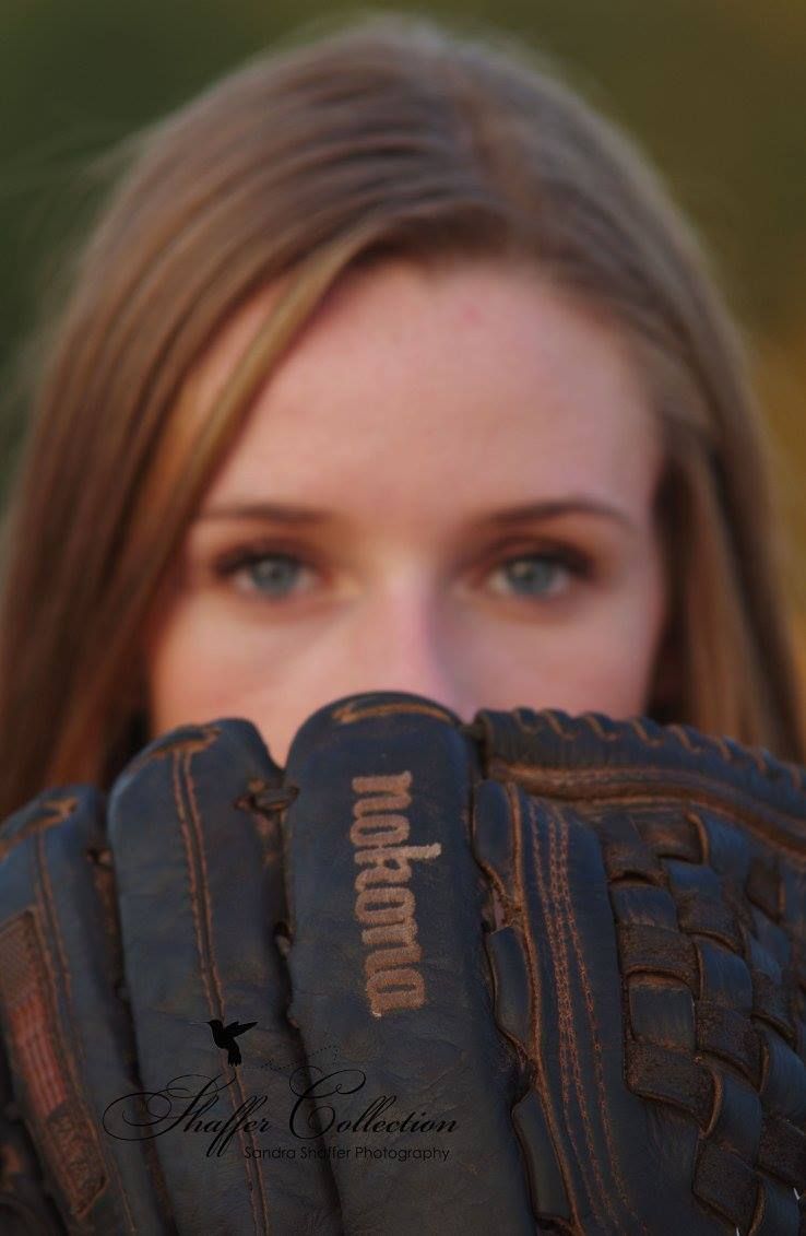 Close-up sports portrait featuring leather baseball glove and natural lighting.