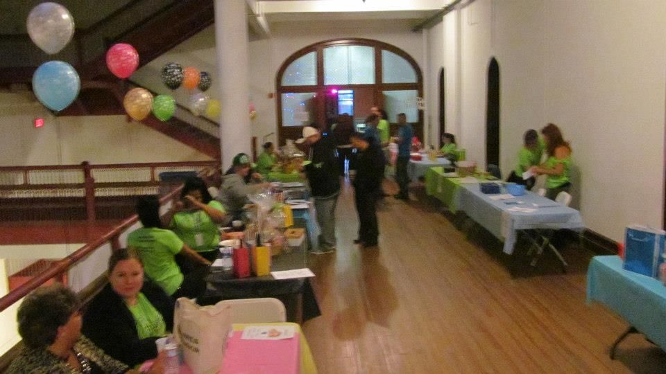 Indoor event space with colorful balloons and tables set up for a gathering.