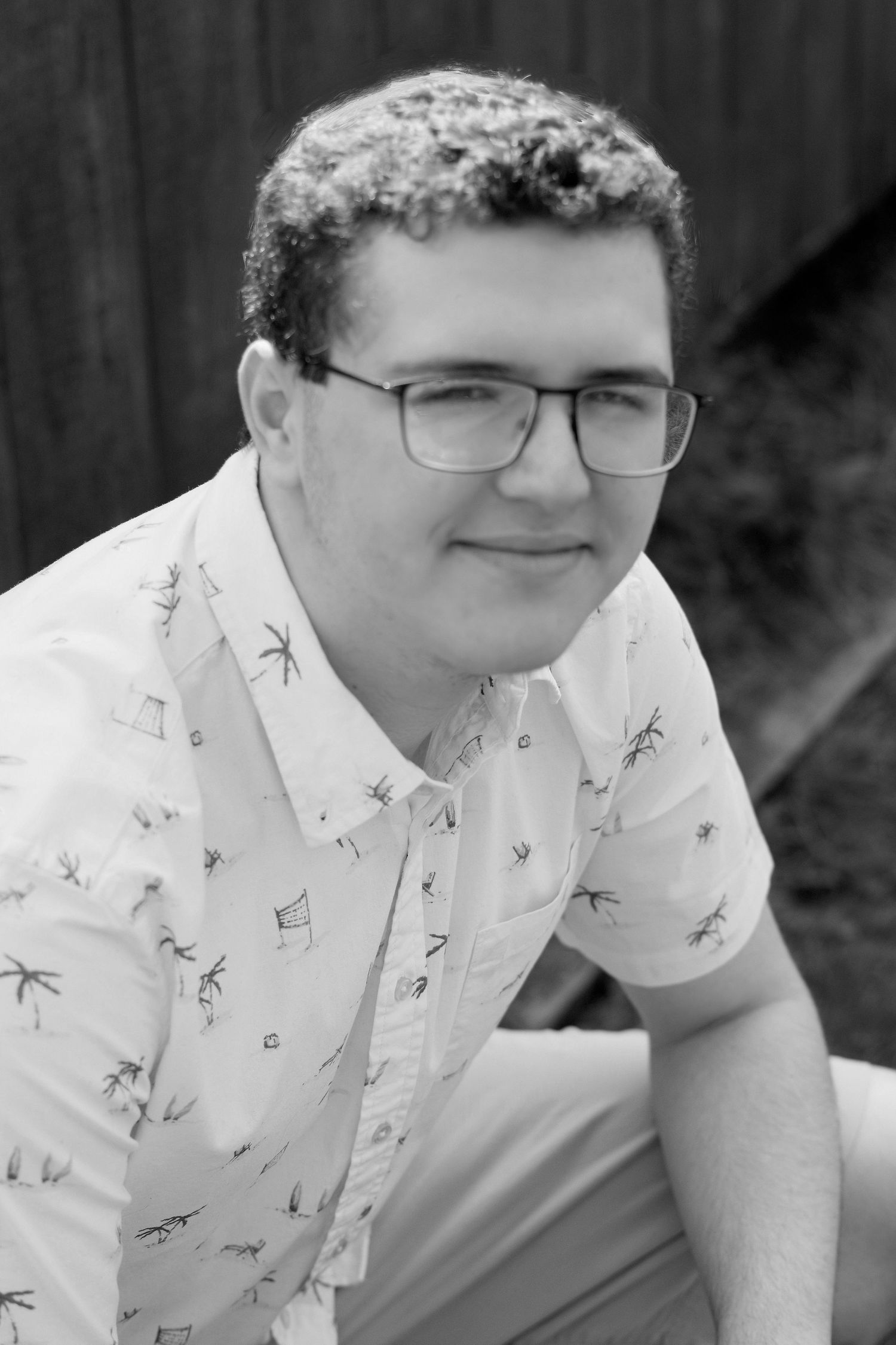 Black and white portrait series wearing patterned short sleeve shirt.