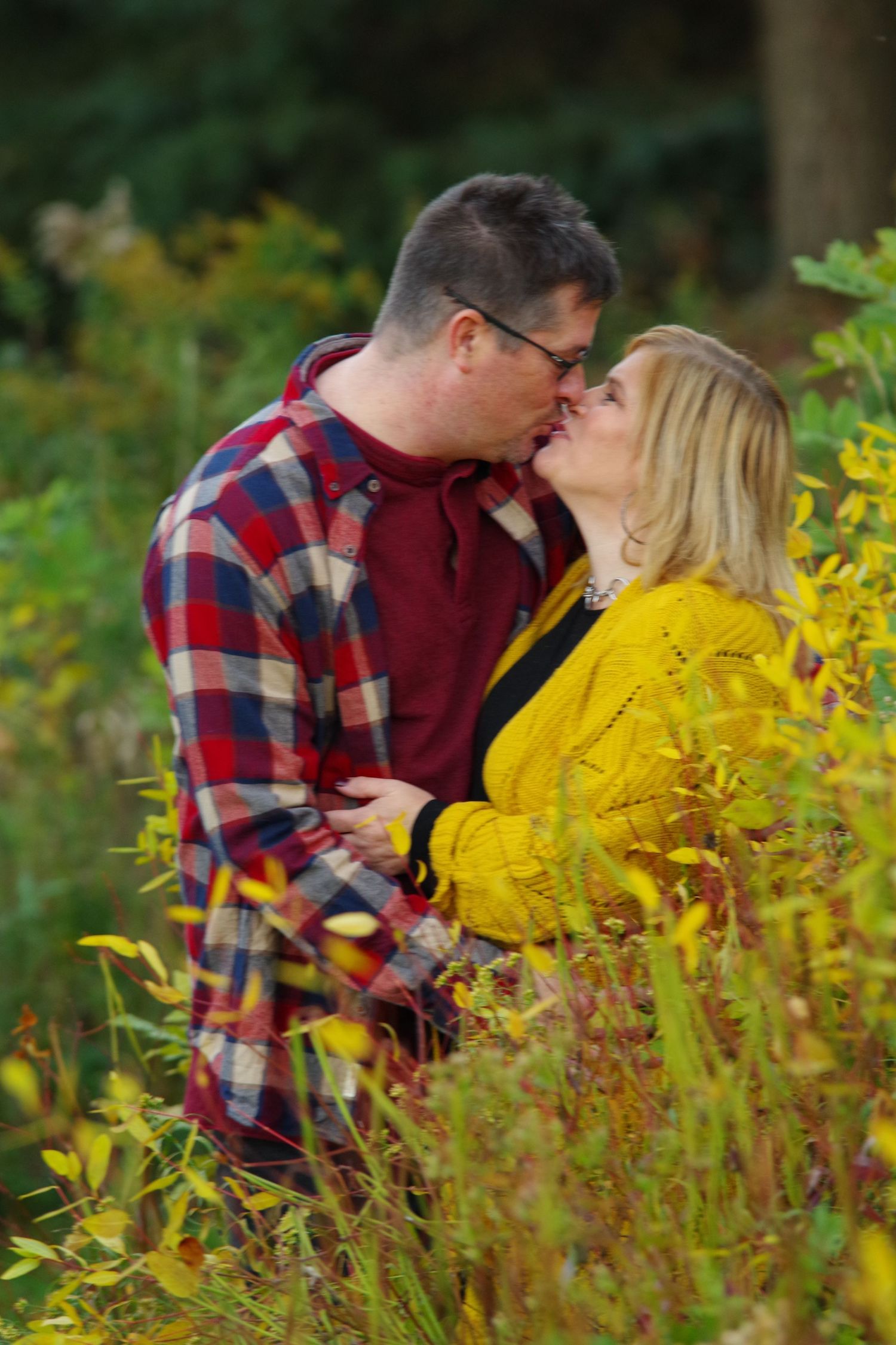 Romantic moment captured among yellow wildflowers and greenery.