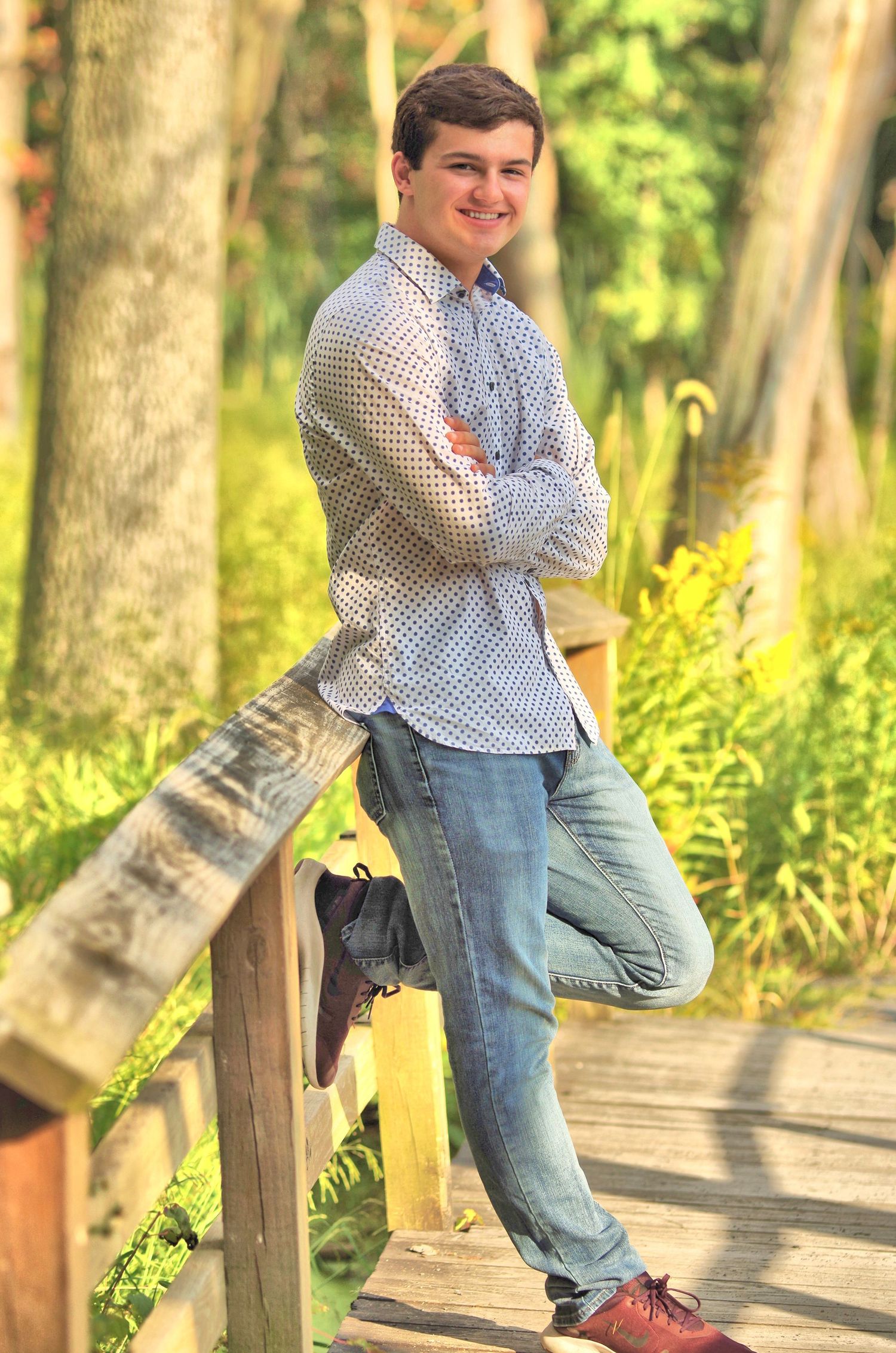 Series of playful poses on a wooden boardwalk surrounded by trees and natural light.