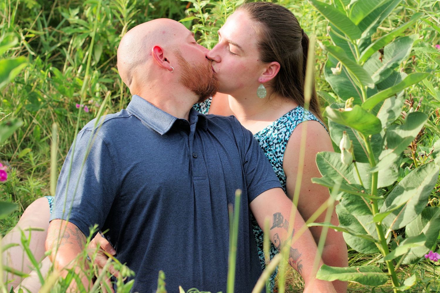 Romantic moment captured in a lush garden setting with greenery.