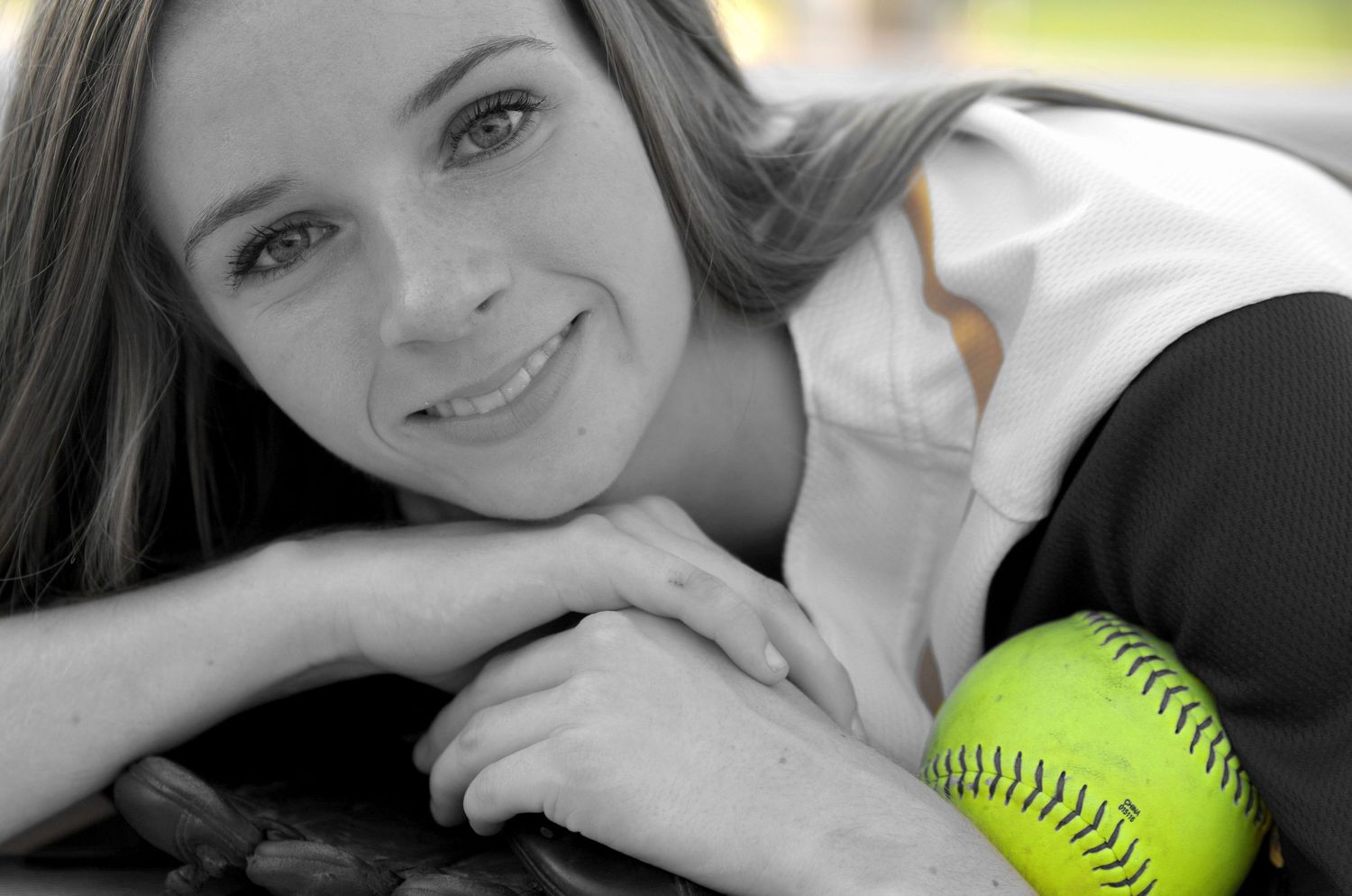 Black and white portrait with neon softball accent.